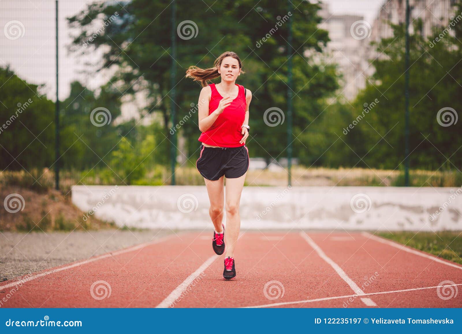 Beautiful Young Athlete Caucasian Woman with Big Breasts in Red T-shirt and  Short Shorts Jogging, Running in the Stadium with Red Stock Image - Image  of bodybuilder, looking: 122235197