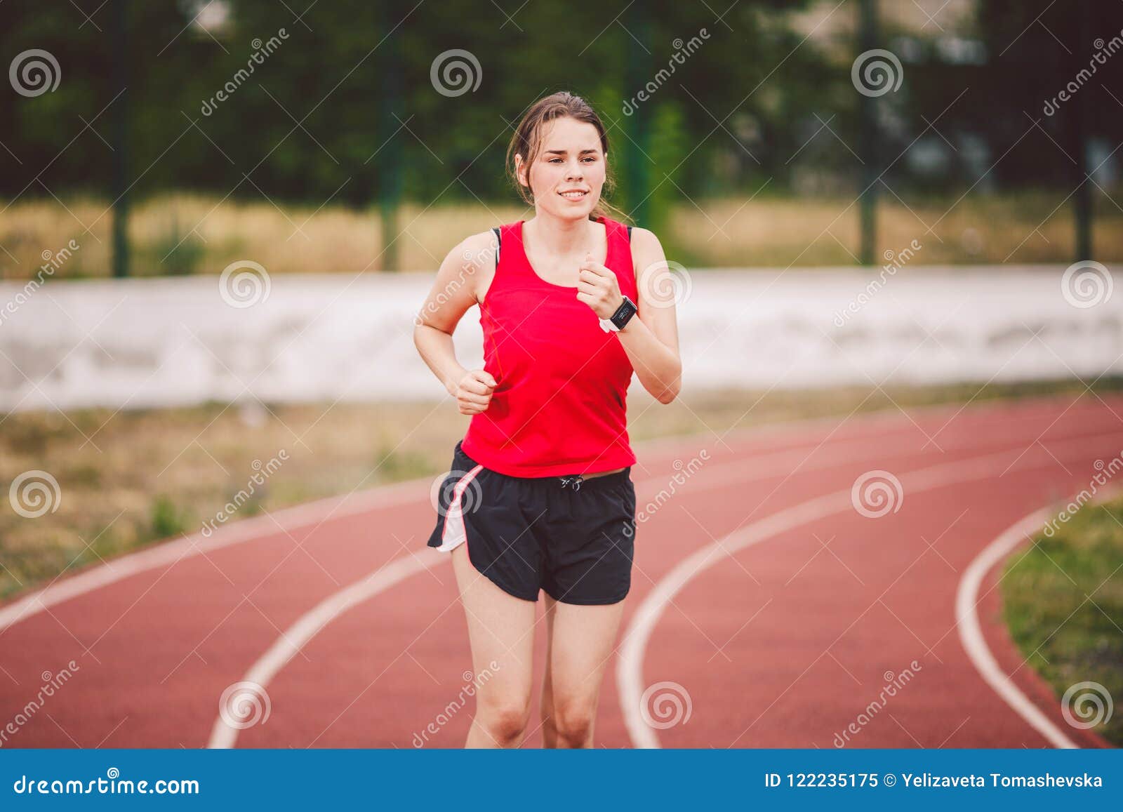 Beautiful Young Athlete Caucasian Woman with Big Breasts in Red T-shirt and  Short Shorts Jogging, Running in the Stadium with Red Stock Image - Image  of leggings, endurance: 122235175