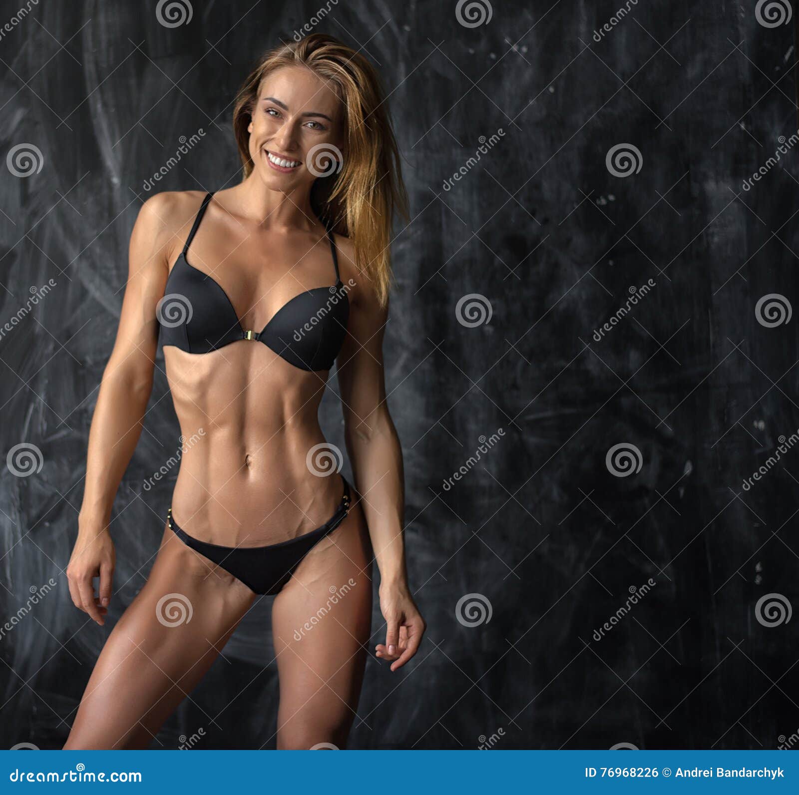 Beautiful Young Athletic Girl in Underwear on Dark Background