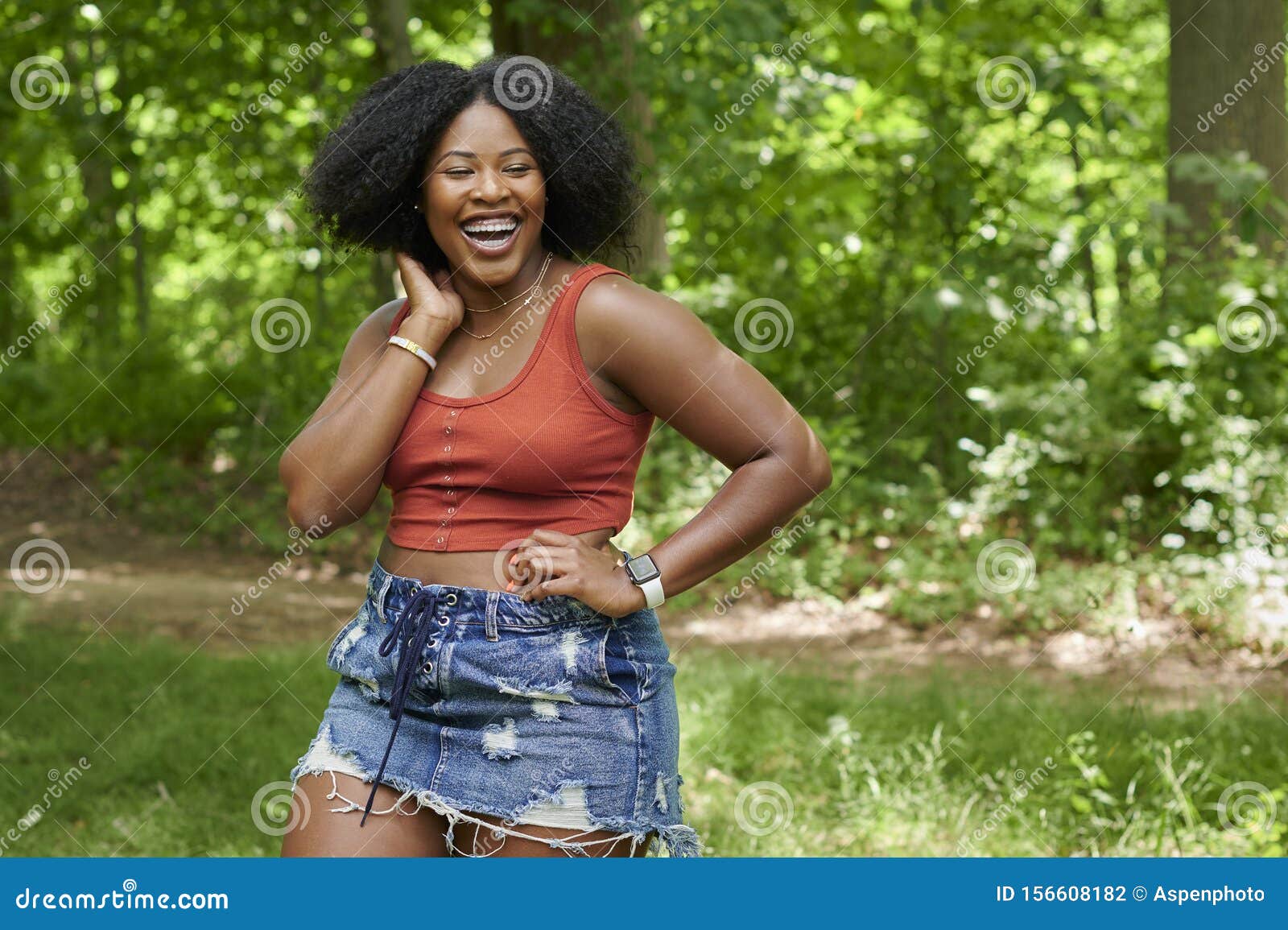 Beautiful Young Black Woman Poses in Orange Tank Top and Denim ...