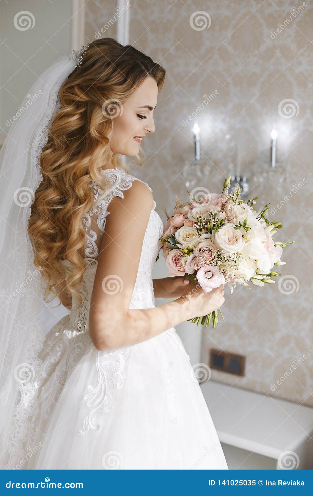 Beautiful Young Blonde Bride with Stylish Wedding Hairstyle in a White Fashionable Dress with a Bouquet of Flowers in Stock Image - Image of flowers, posing: 141025035 Beautiful Young Blonde Bride with Stylish Wedding Hairstyle in a White Fashionable Dress with a Bouquet of Flowers in Stock Image - Image of flowers, posing: 141025035