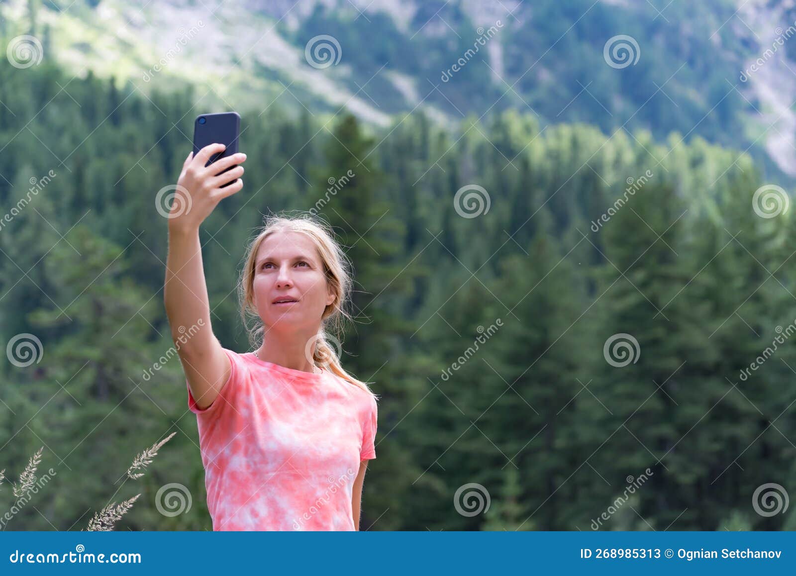 Blonde girl with a ponytail taking a selfie - wide 1