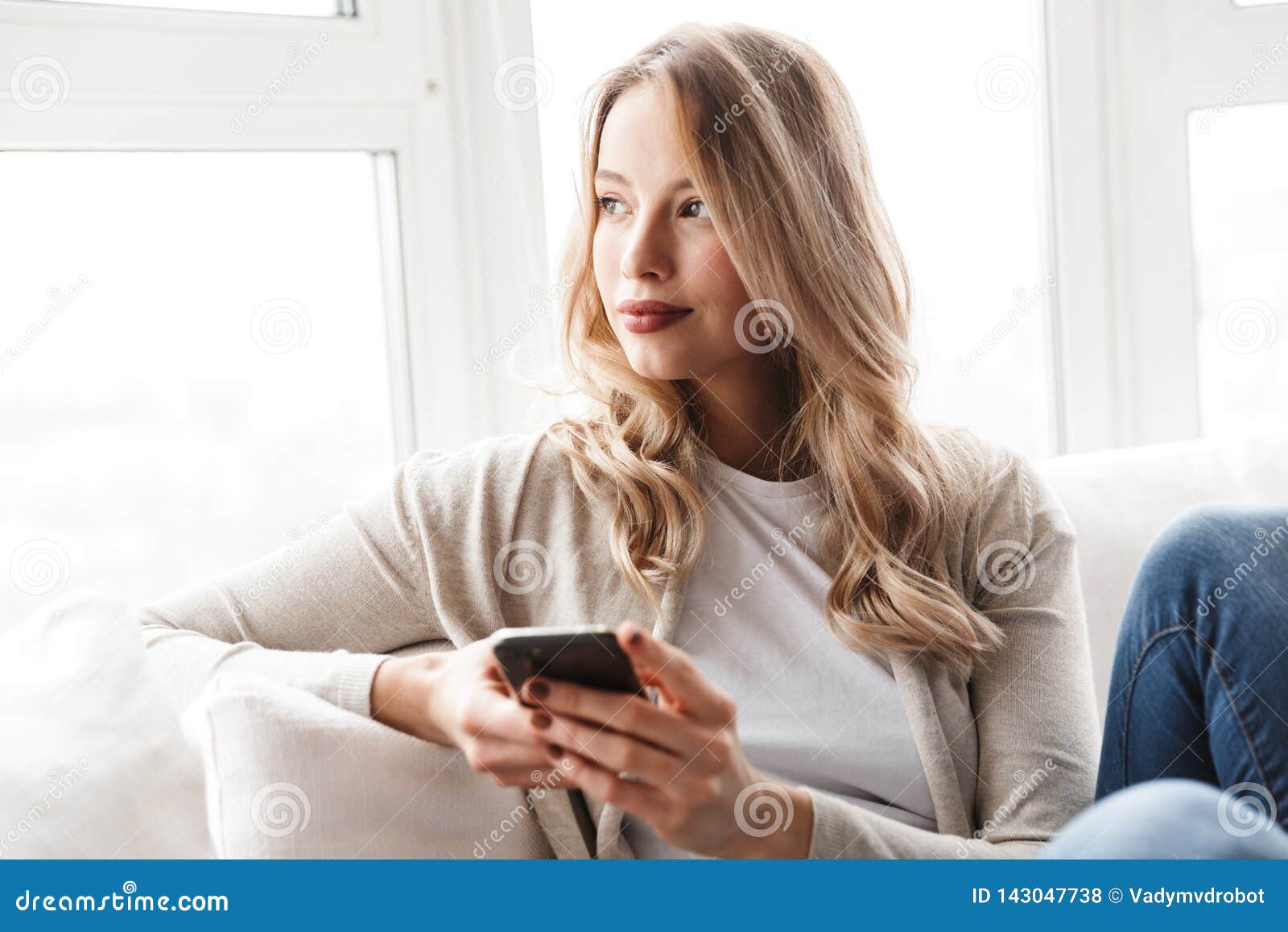 Beautiful Young Blonde Woman Relaxing on a Couch Stock Photo - Image of ...