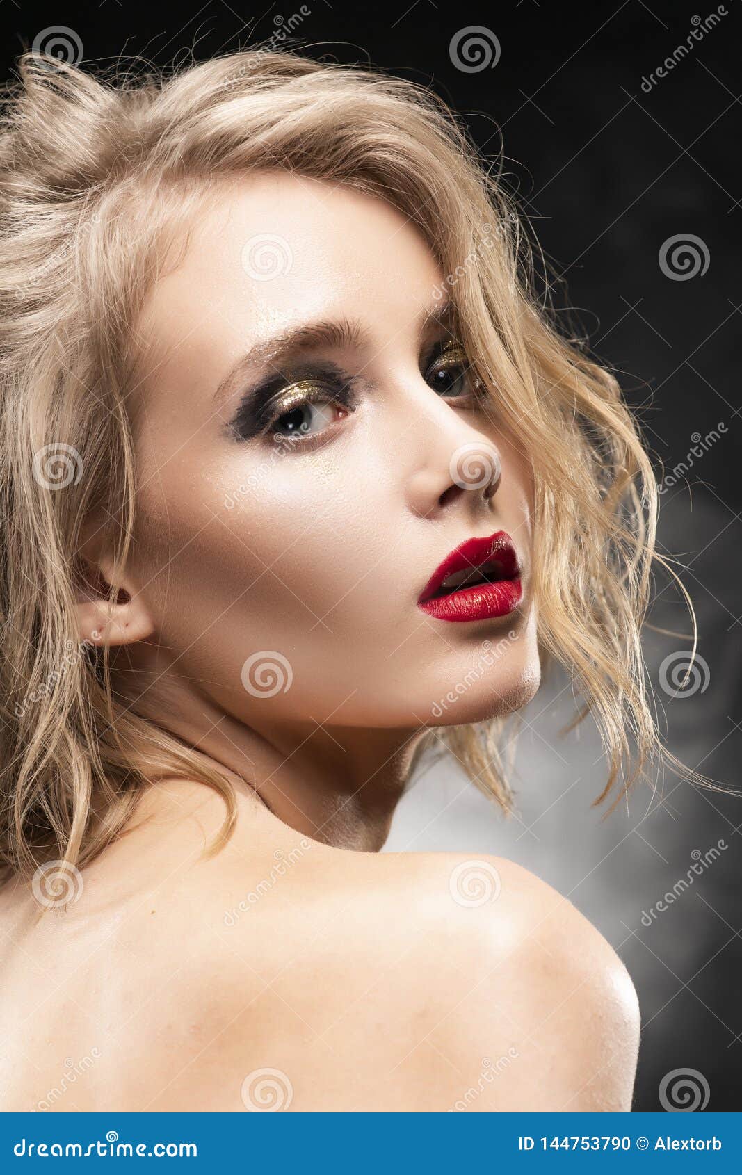 Beautiful Young Braless Slim Blonde Girl With Disheveled Hair And Aggressive Makeup Wearing An