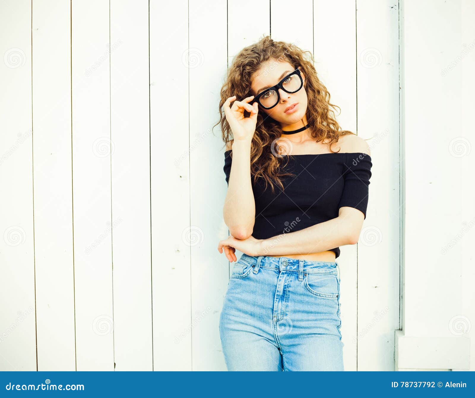 Beautiful Young Brunette Woman with Long Hair Dressed in a Top and Jeans Posing in Style 70 and in Glasses on a Warm Stock Photo - Image of model, portrait: 78737792 Beautiful Young Brunette Woman with Long Hair Dressed in a Top and Jeans Posing in Style 70 and in Glasses on a Warm Stock Photo - Image of model, portrait: 78737792