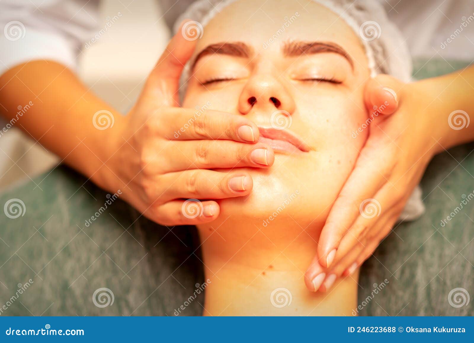 Beautiful Young Caucasian Woman With Closed Eyes Receiving A Facial Massage In A Beauty Salon