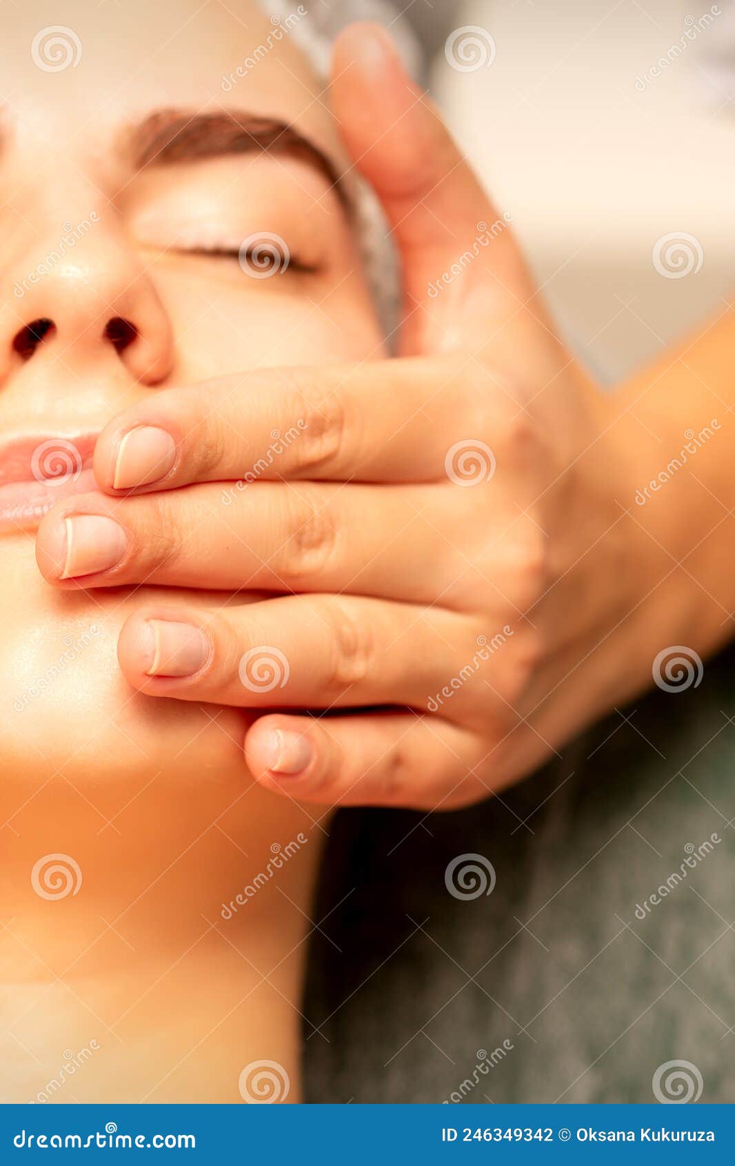 Beautiful Young Caucasian Woman With Closed Eyes Receiving A Facial Massage In A Beauty Salon