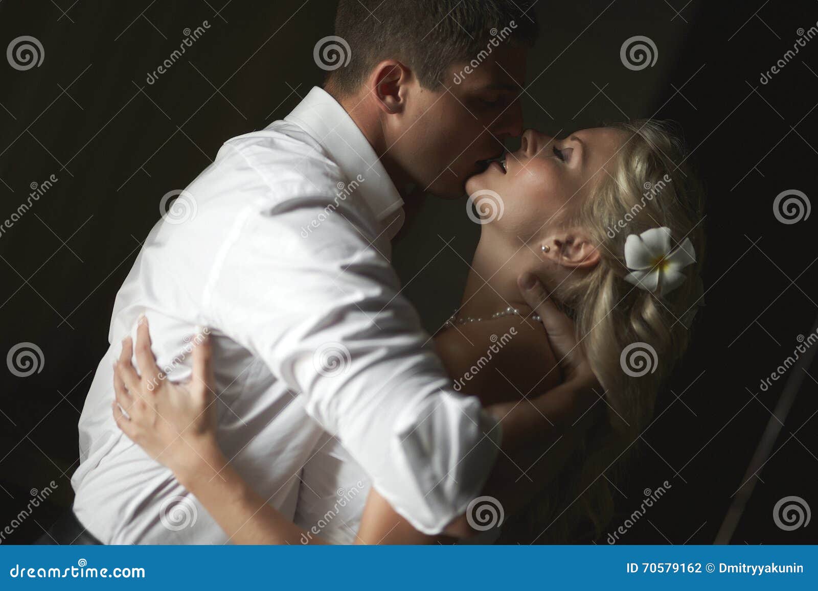 beautiful young couple kissing with emotional embrace.
