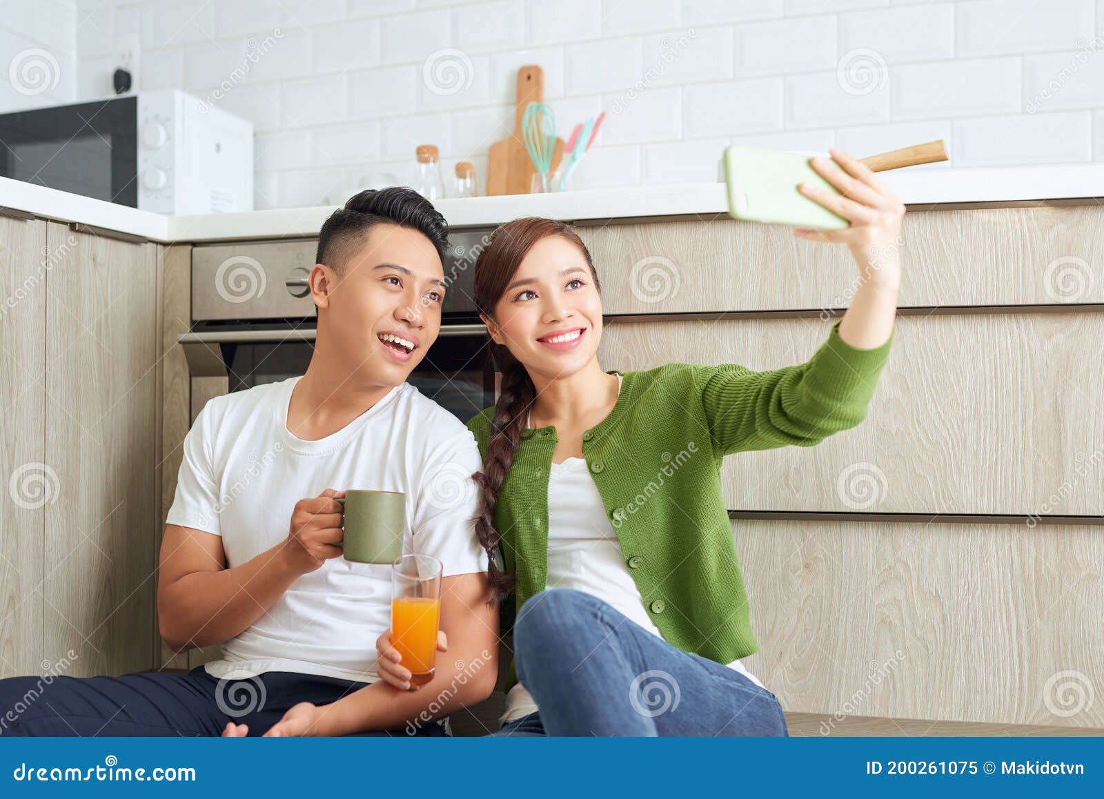 Beautiful Young Couple in Love Sitting on the Kitchen Floor, Taking ...