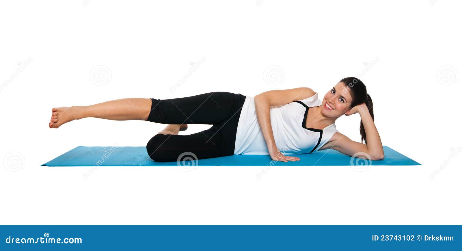 beautiful young female exercising on a blue matt