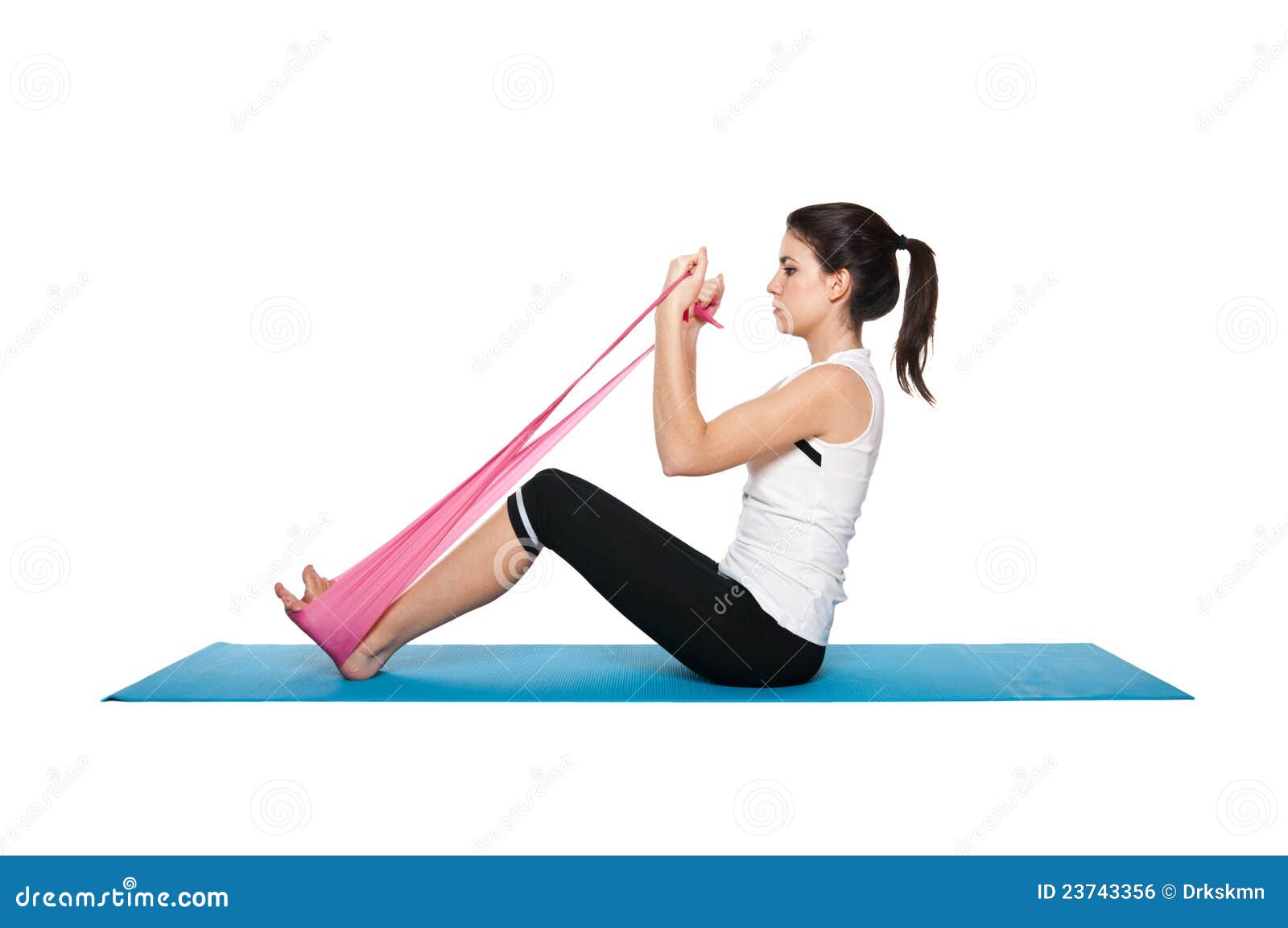 beautiful young female exercising on a blue matt