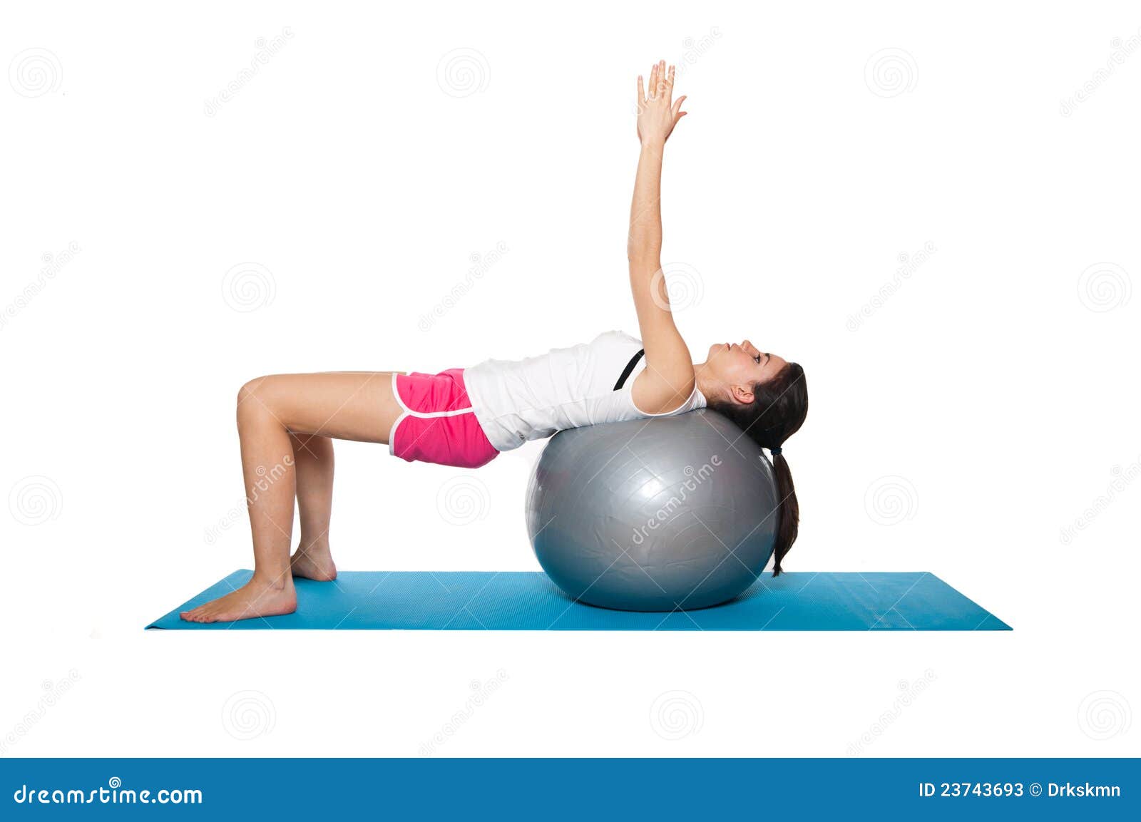 beautiful young female exercising on a blue matt
