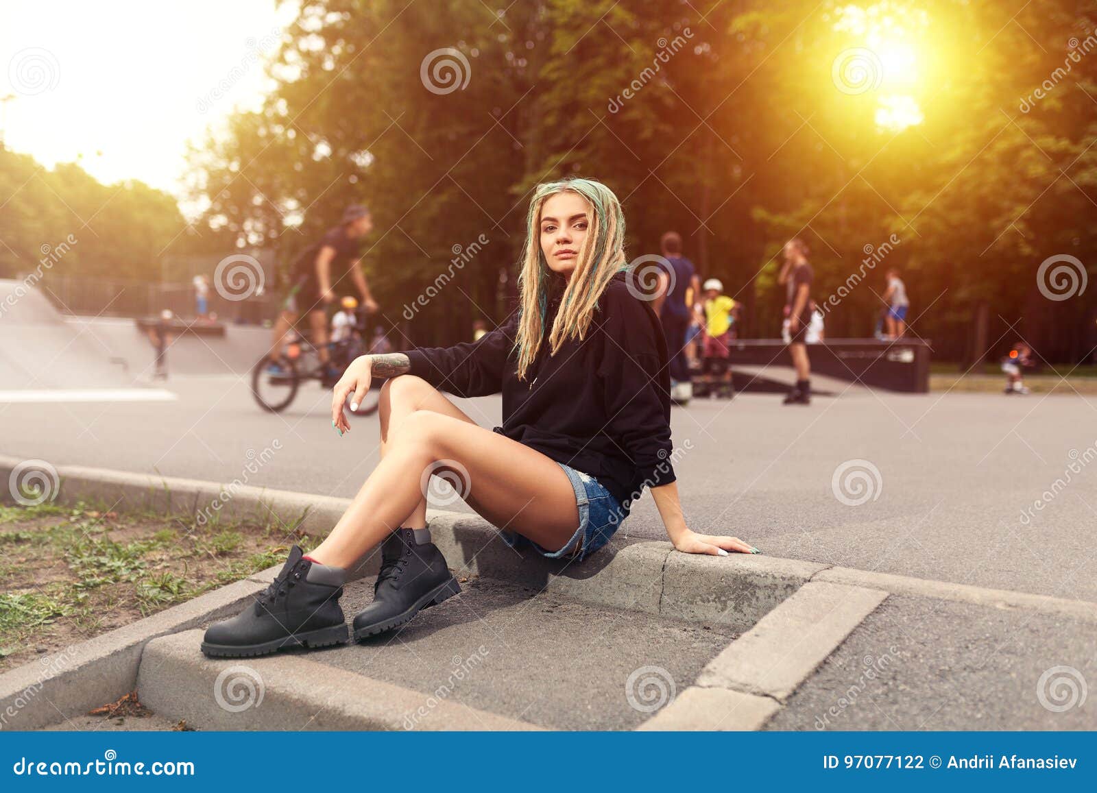 Beautiful Young Fitness Woman In Black Hoodie Sitting Near