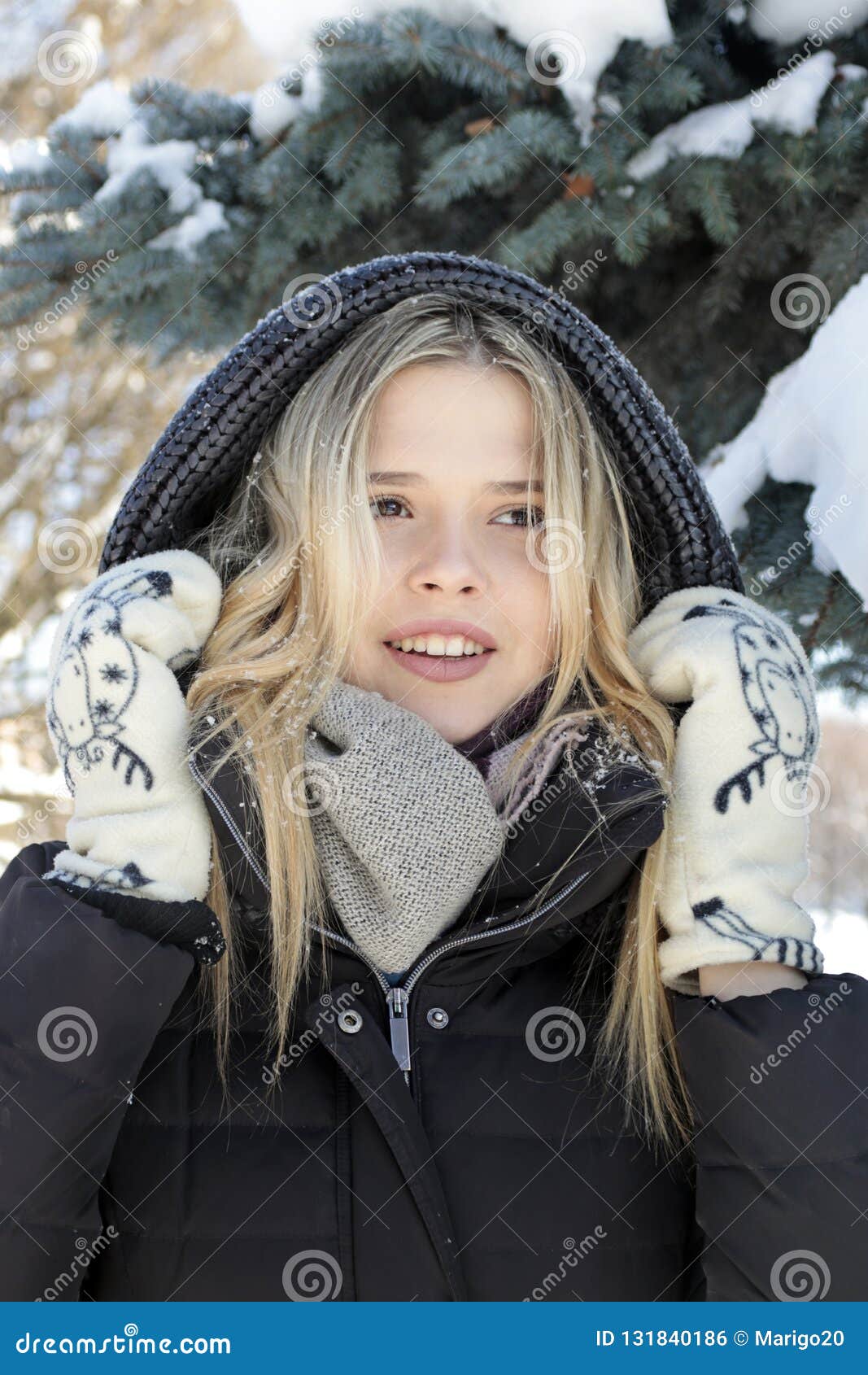 Beautiful Young Girl with Blond Hair Walks in the Park in Winter on the ...