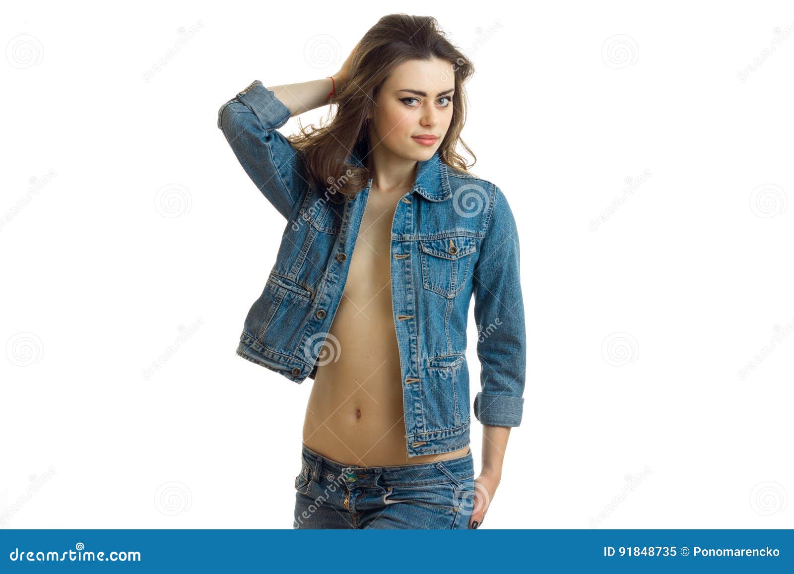 beautiful young girl in denim jacket with a naked belly poses on camera  Stock Photo | Adobe Stock