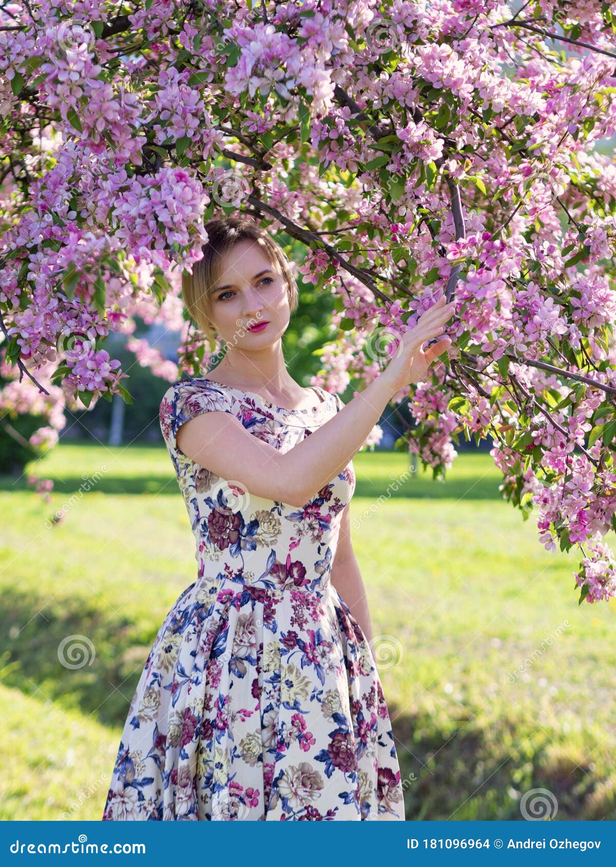 Beautiful Young Girl In A Flowered Garden Tender Woman In A Dress With A Floral Print Among