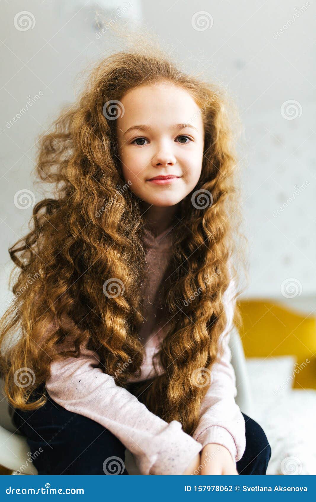 Beautiful Girl with Long Curly Hair Smiles and Looks into the Camera Stock  Photo - Image of gift, hair: 157978062