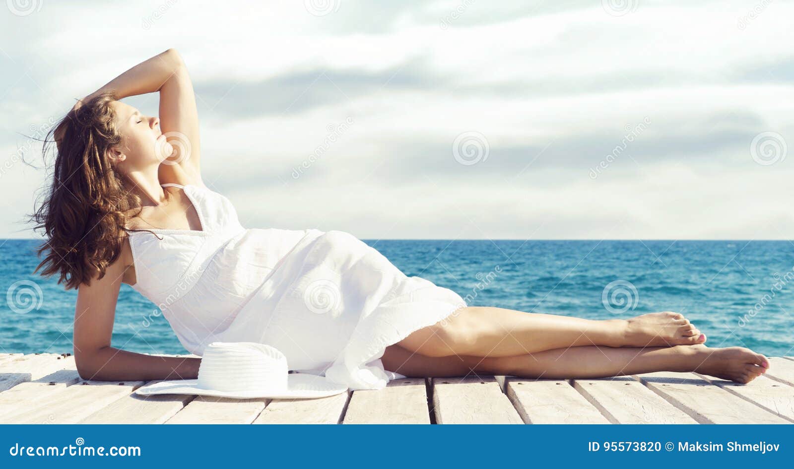 Beautiful, Young Girl Sitting on a Pier in a White Dress. Summer Stock ...