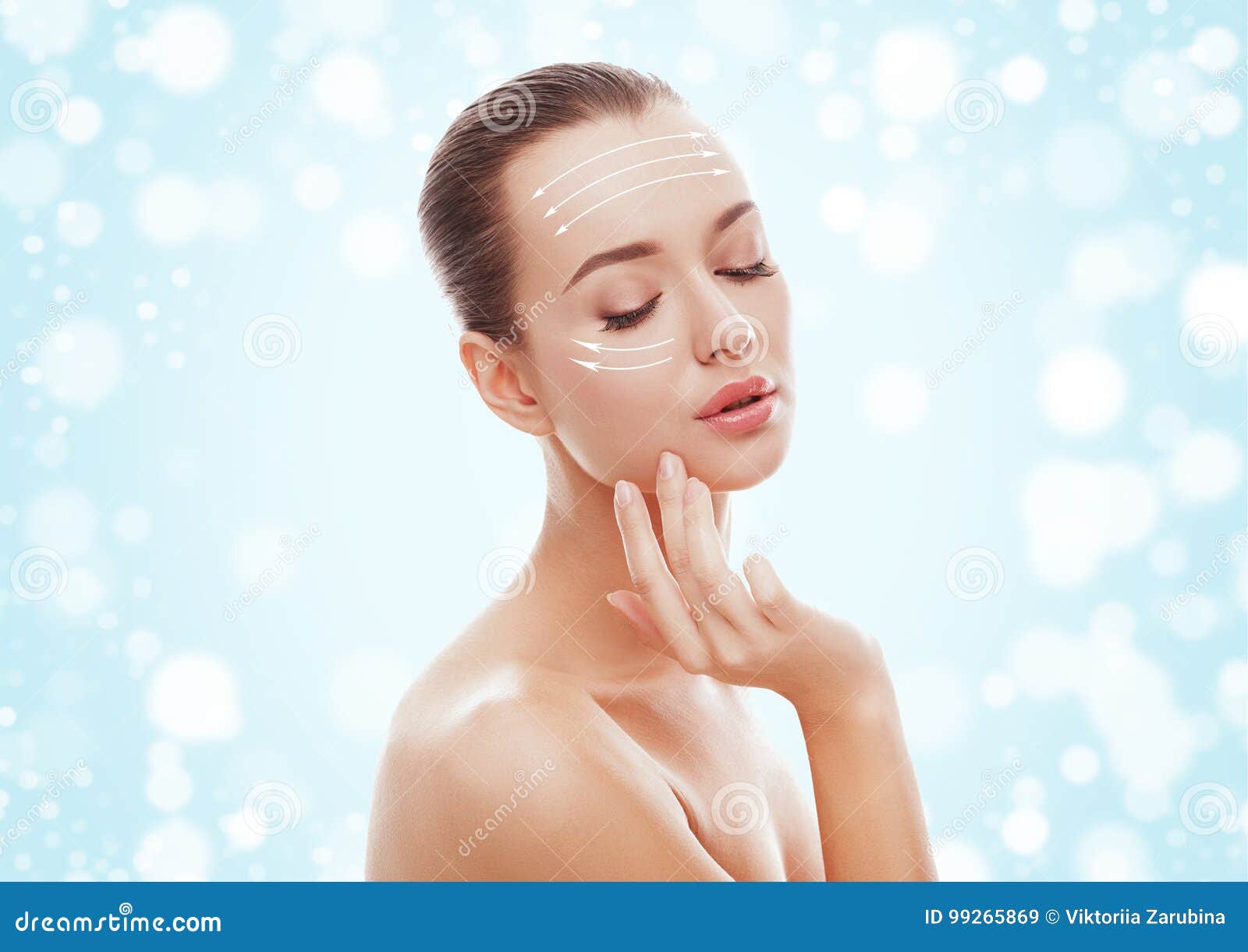 beautiful young girl touching her face on blue background and snow. plastic surgery, facelift and rejuvenation concept.