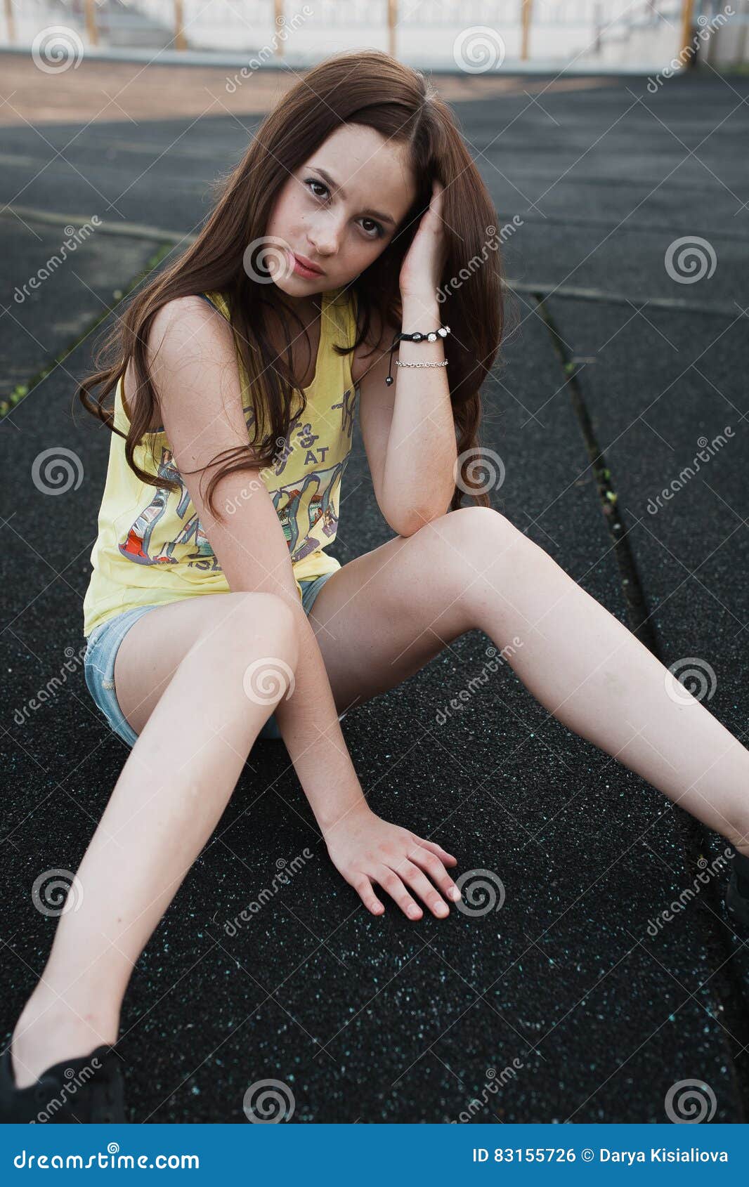 Beautiful Young Hipster Girl Sitting In The Middle Of Aspha