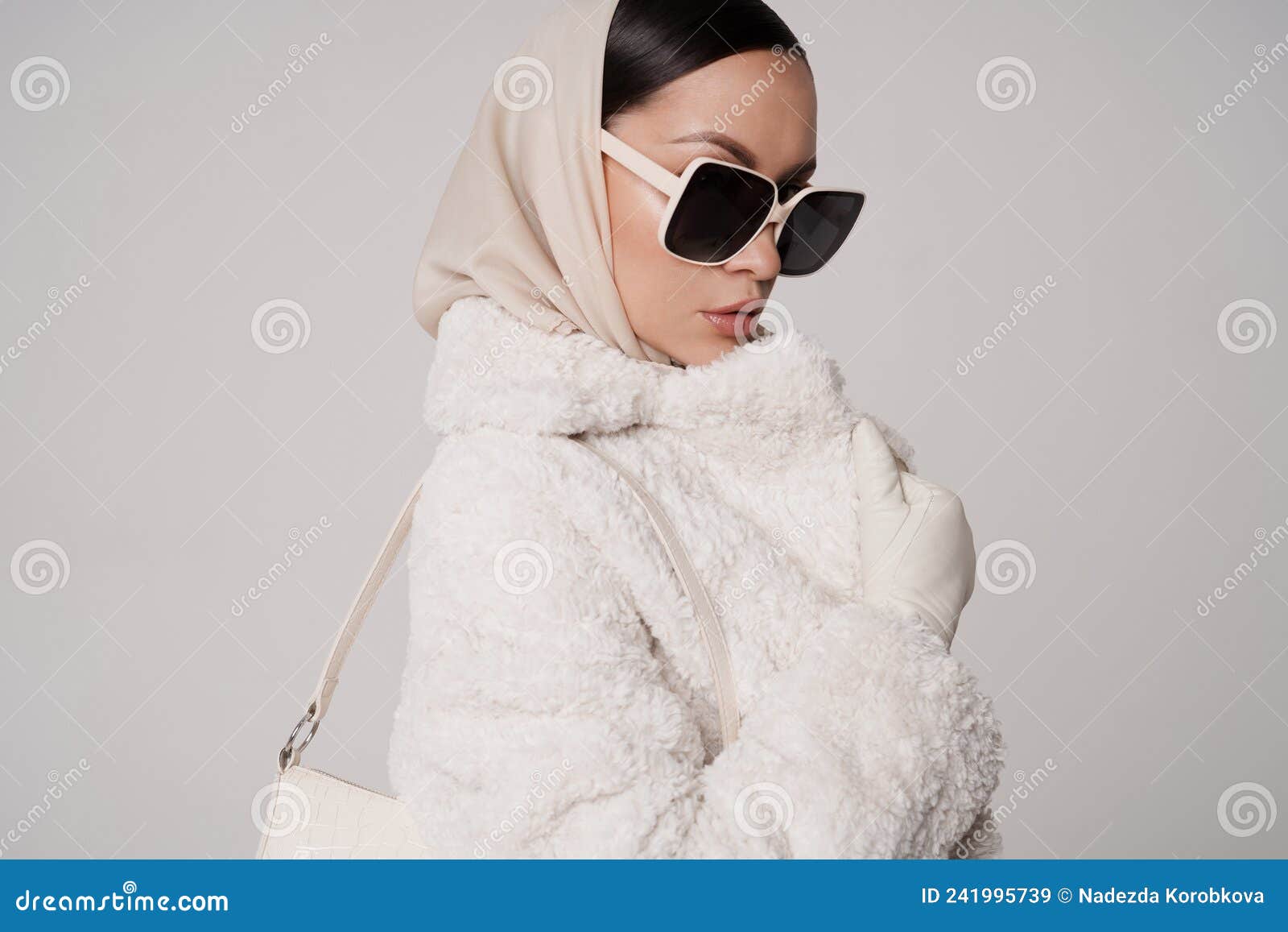 beautiful young lady in a white faux fur coat