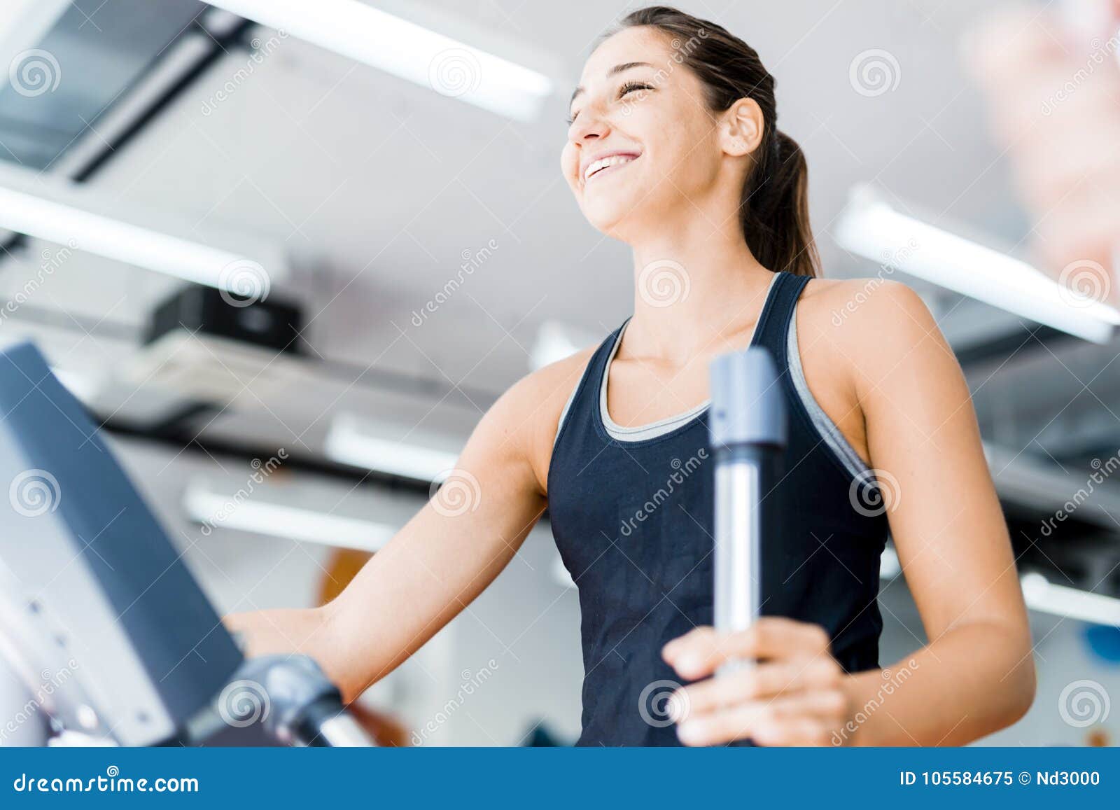 Beautiful Young Lady Using the Elliptical Trainer Stock Image - Image ...
