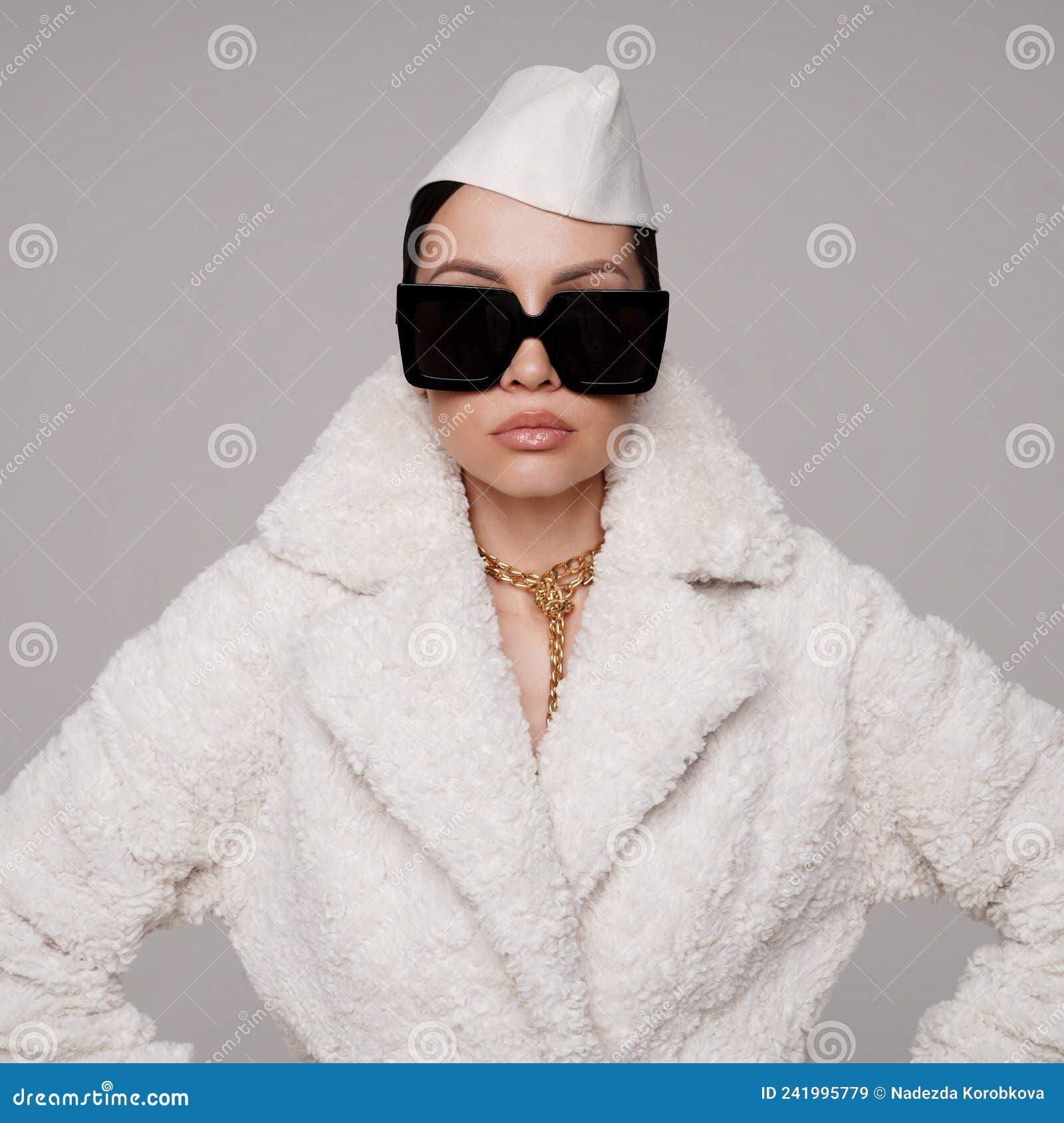 beautiful young lady in a white faux fur coat