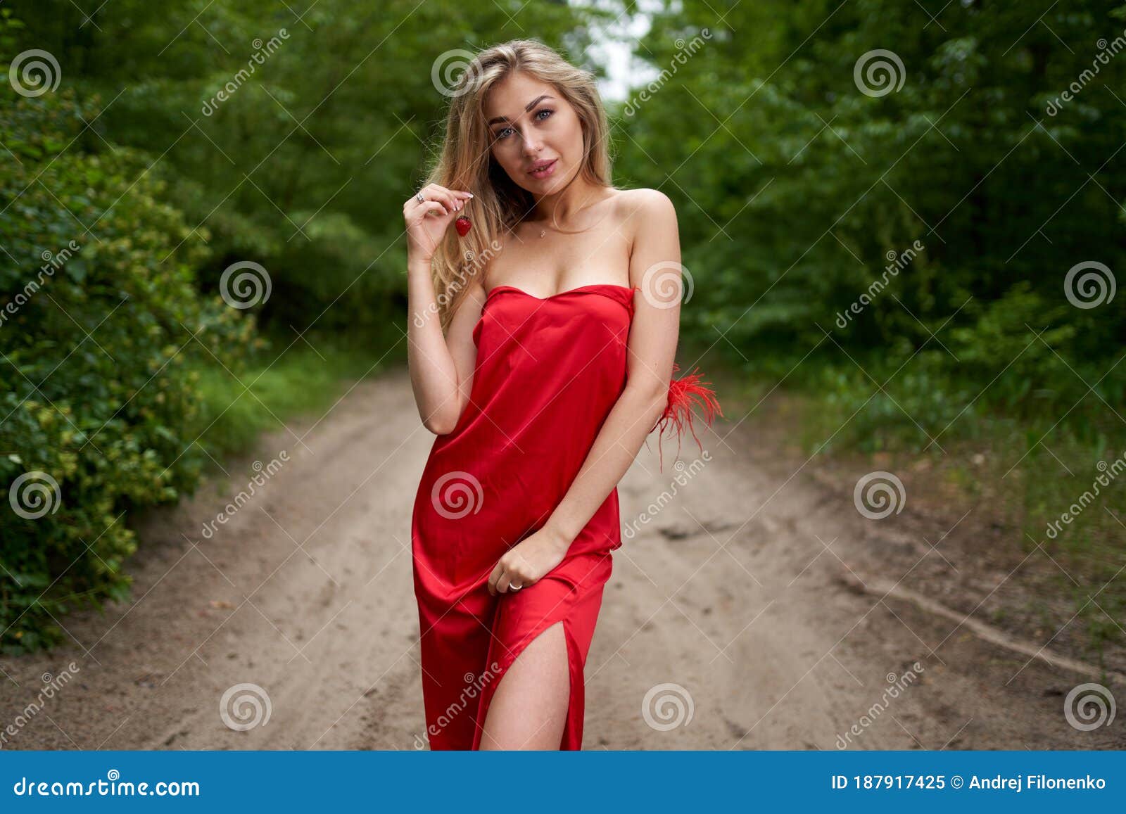 Beautiful Young Long-haired Blonde in a Red Dress Posing on the Road in ...