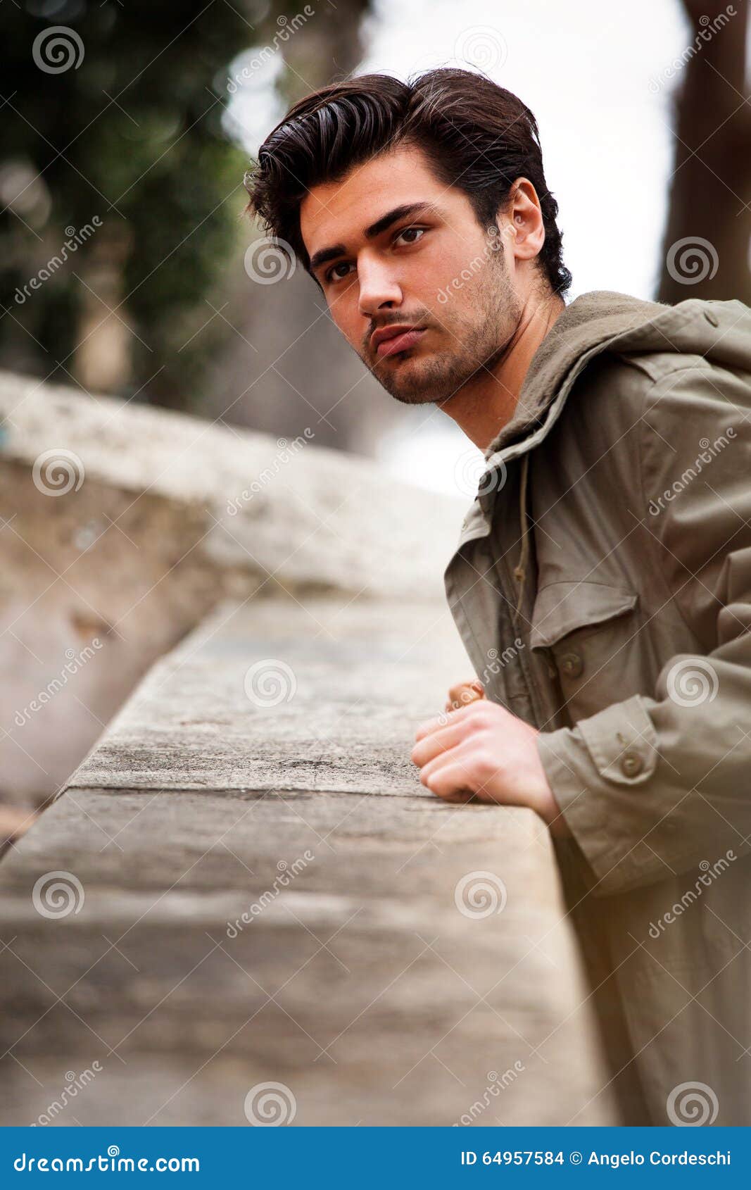 Beautiful Young Man Looking Leaning Against a Wall Stock Photo - Image ...