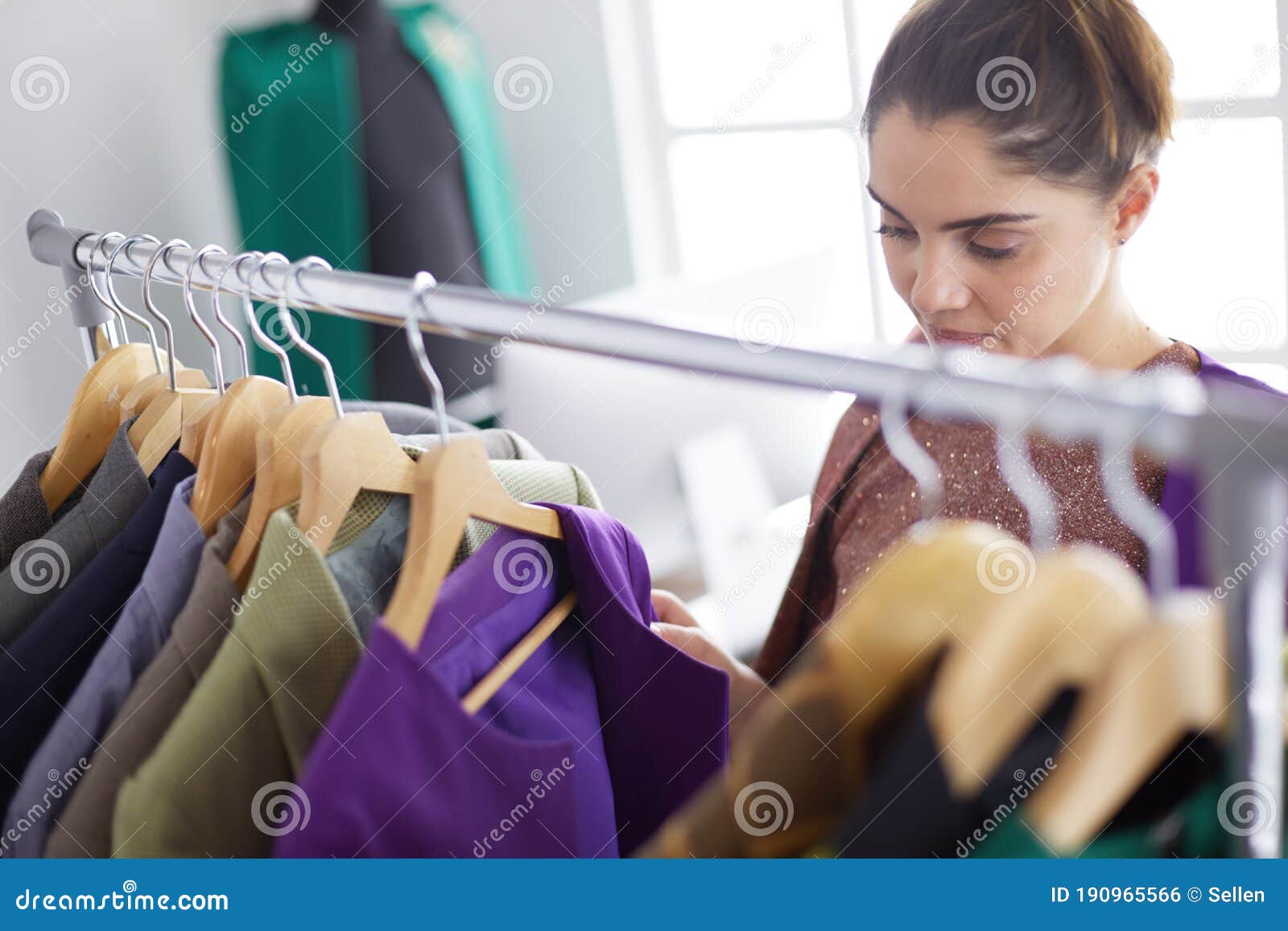 Beautiful Young Stylist Near Rack with Hangers Stock Photo - Image of ...