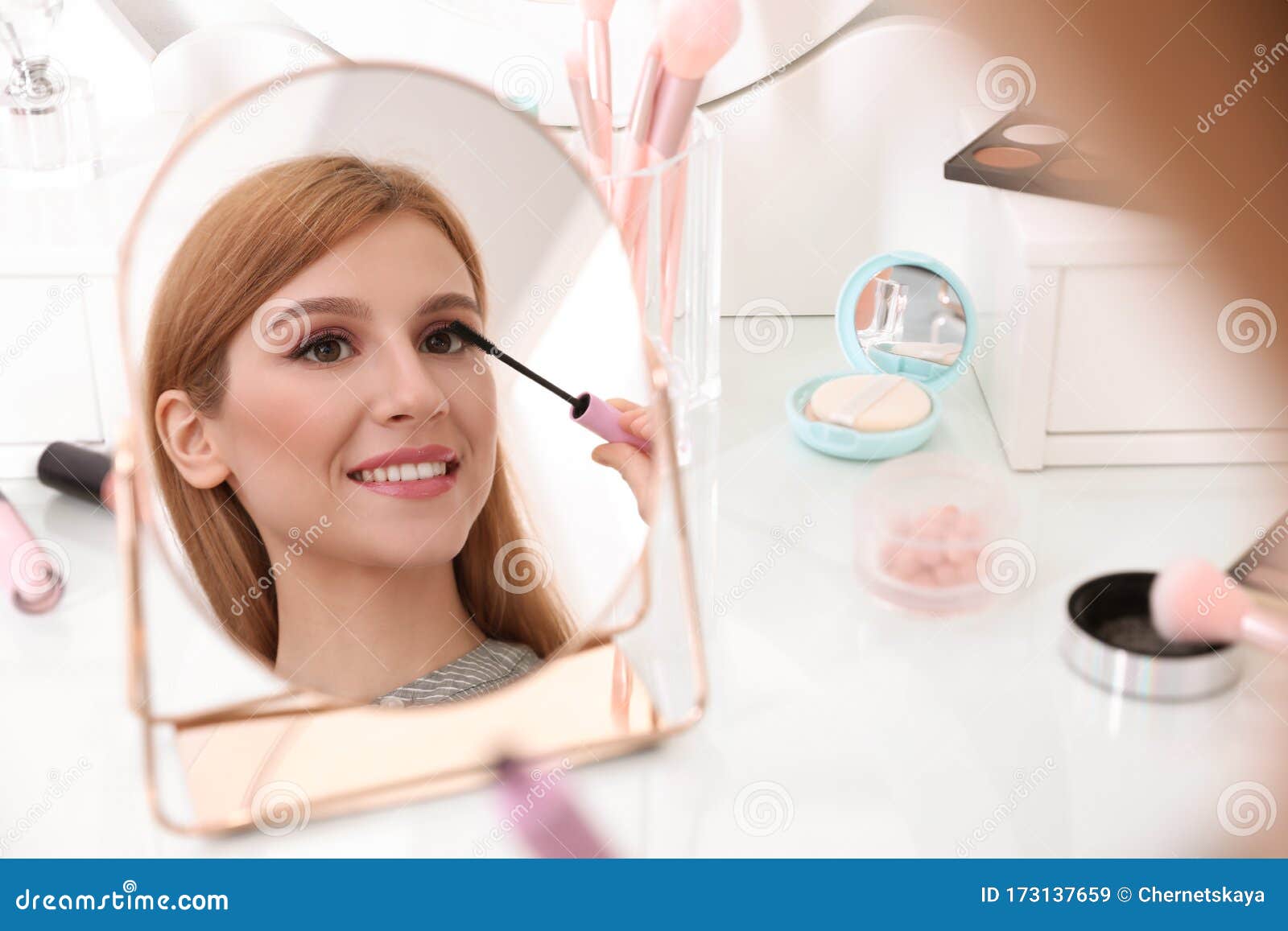 Beautiful Young Woman Applying Makeup Near Mirror Stock ...