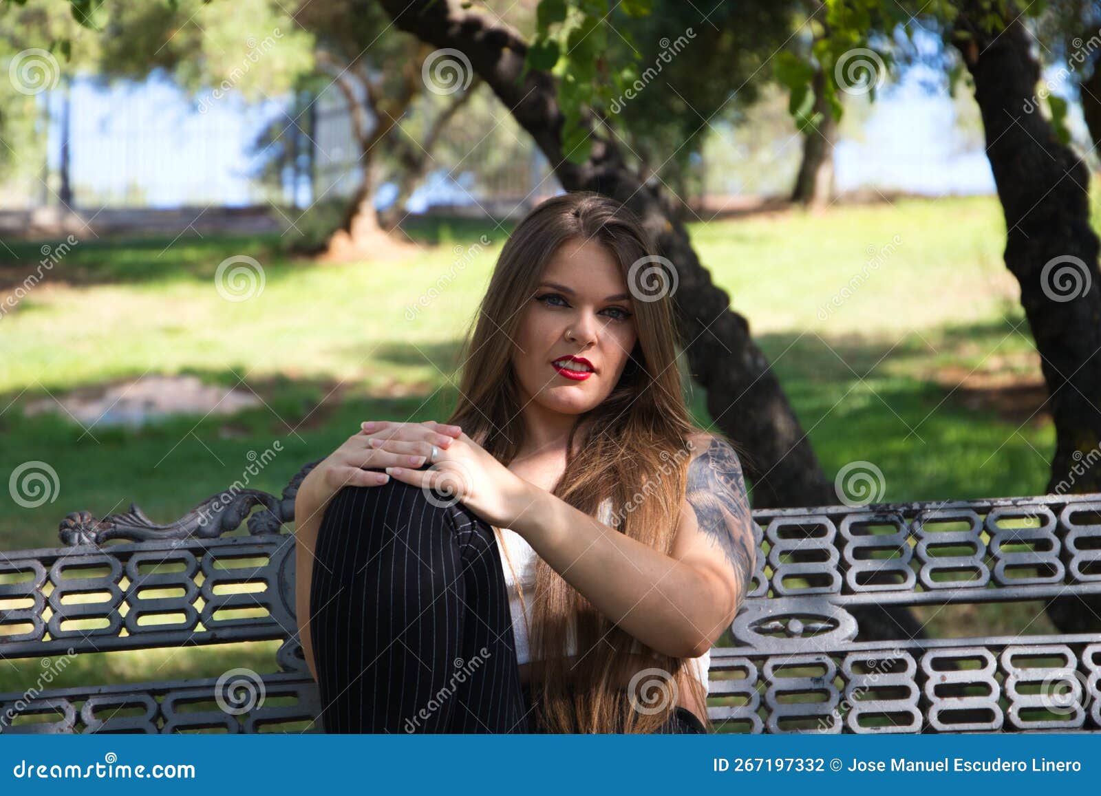 one handsome young man, 20-29 years old, posing, autumn clothes, sitting  bench on city square. night time, dark Stock Photo - Alamy