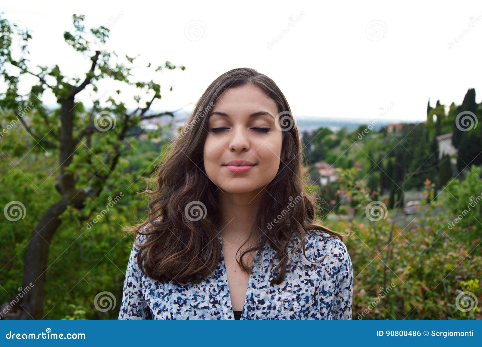 beautiful young woman breathe with closed eyes enjoying the silence quiet tranquil spiritual reflection