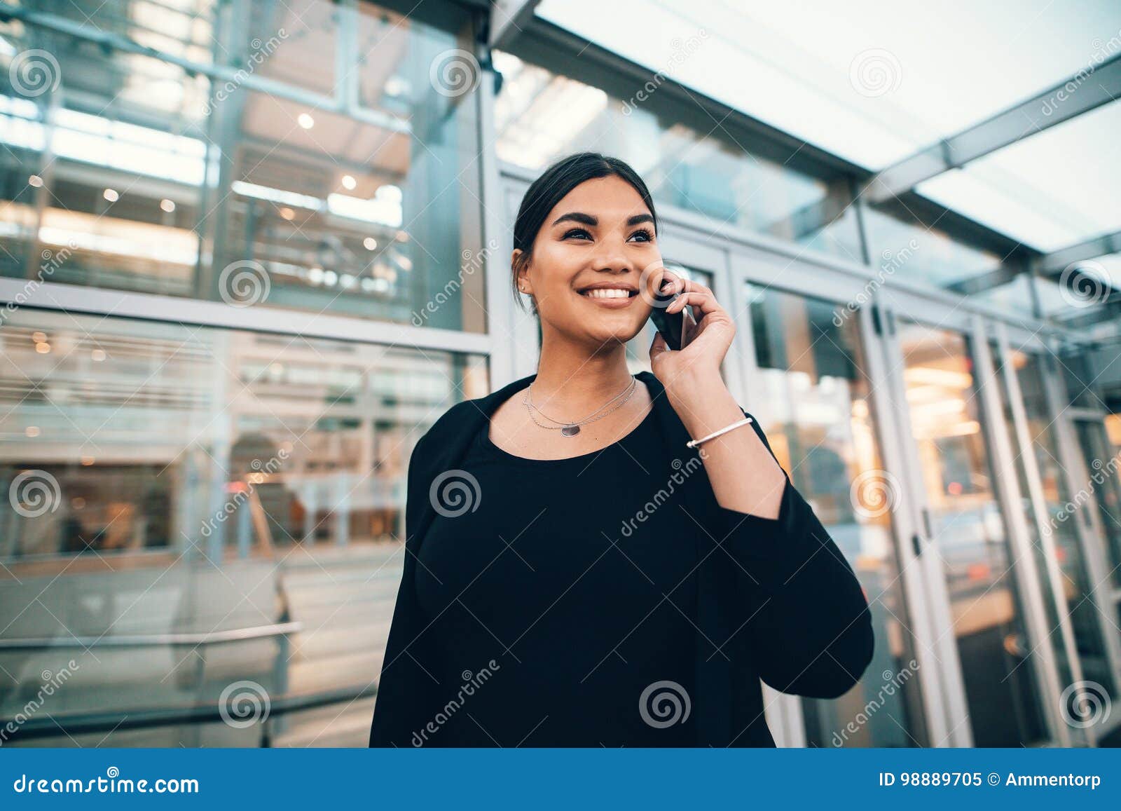 Beautiful Young Woman on Business Trip Talking on Cellphone at a Stock ...
