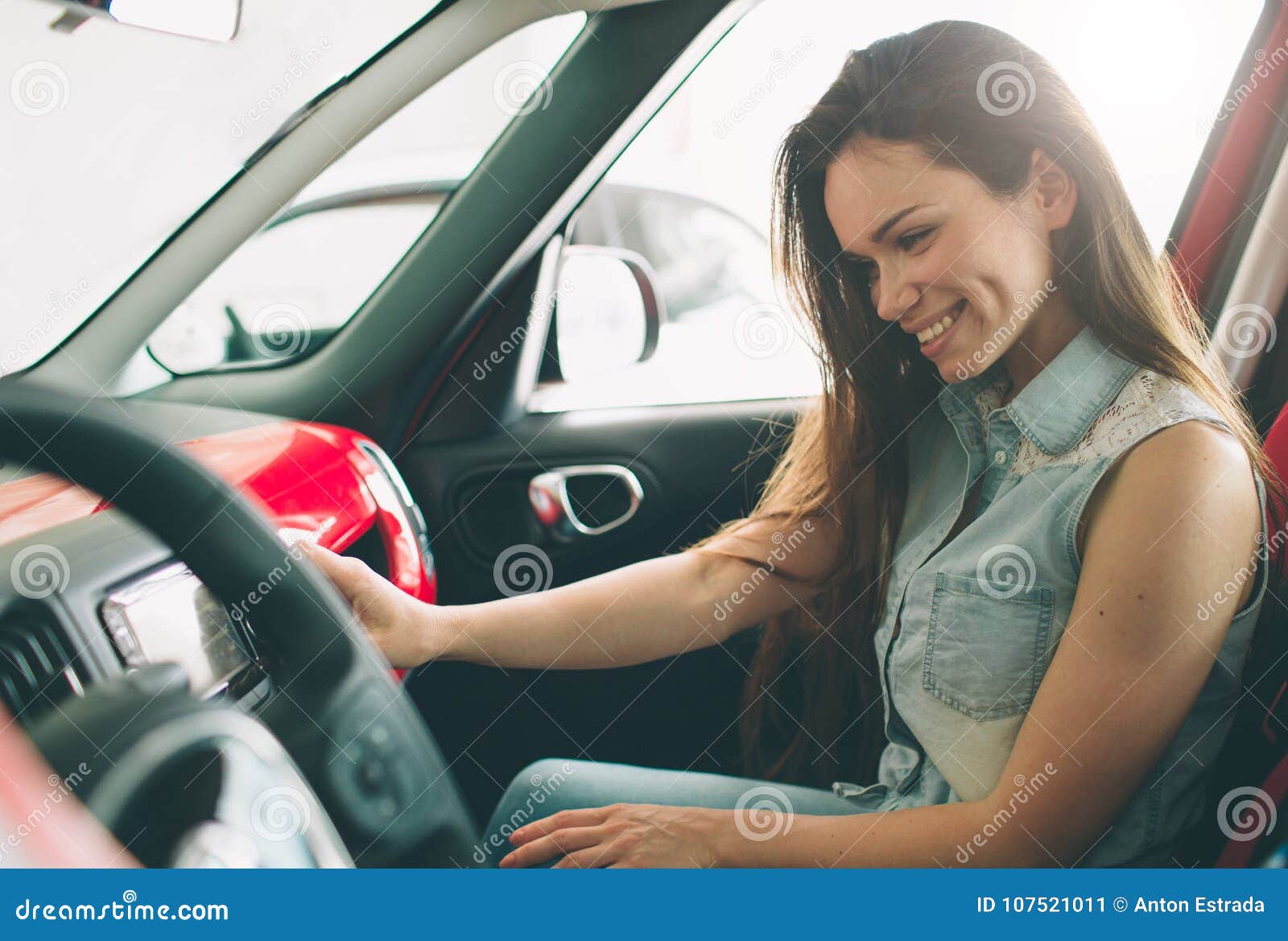 Beautiful Young Woman Buying a Car at Dealership. Female Model Sitting ...