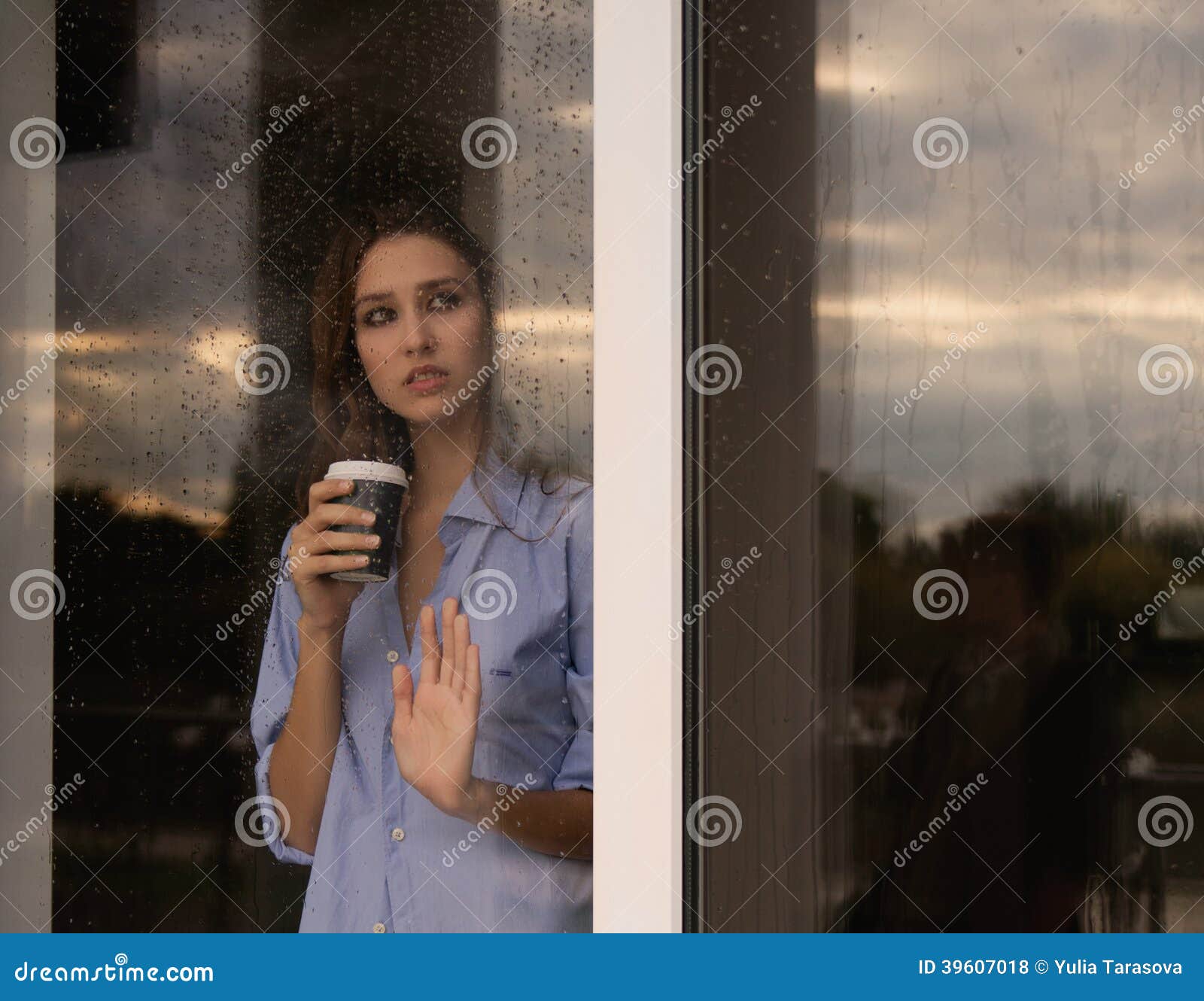 Beautiful Young Woman With Coffee Cup Looking Through The