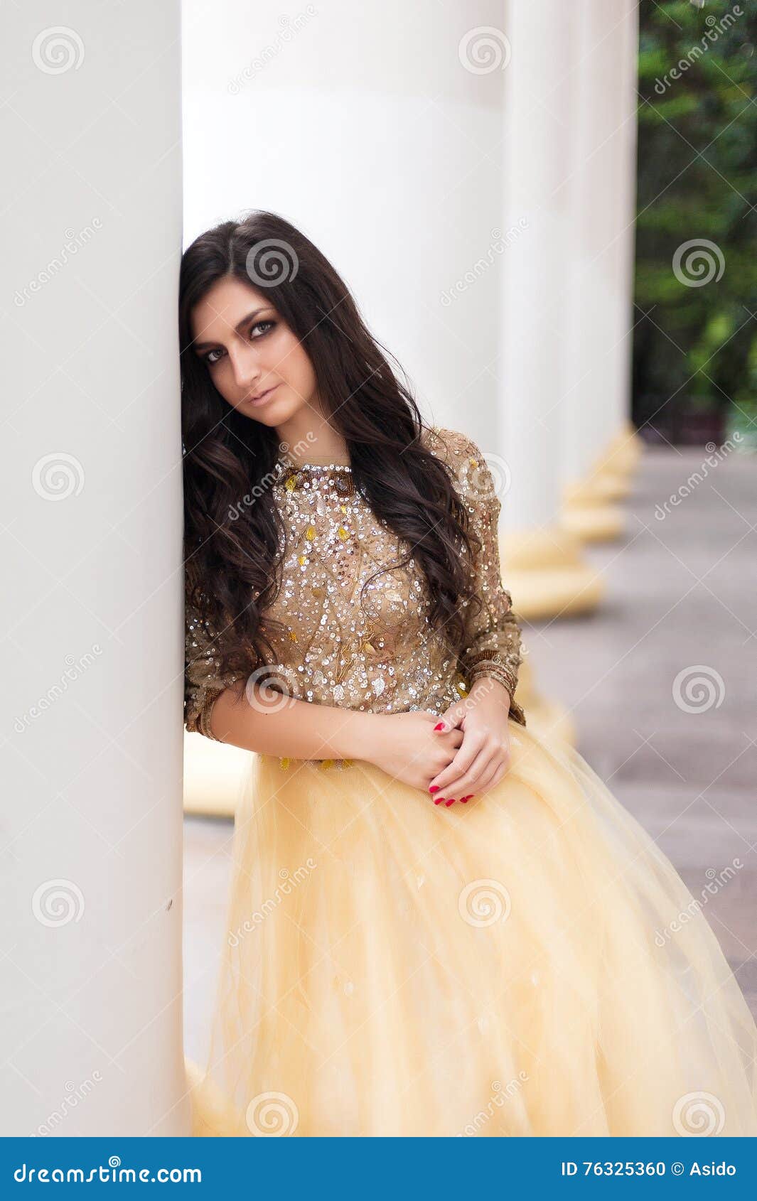 beautiful young woman in gold dress