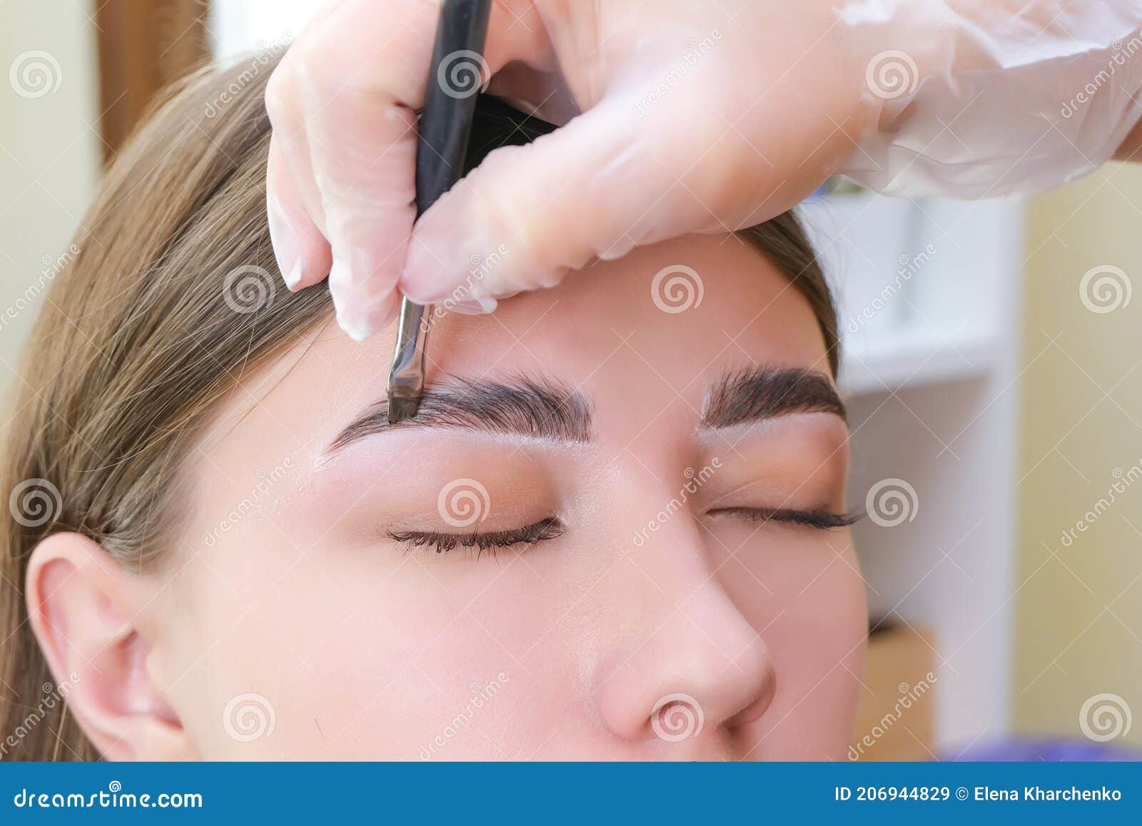beautiful young woman got correction of eyebrows in a beauty salon