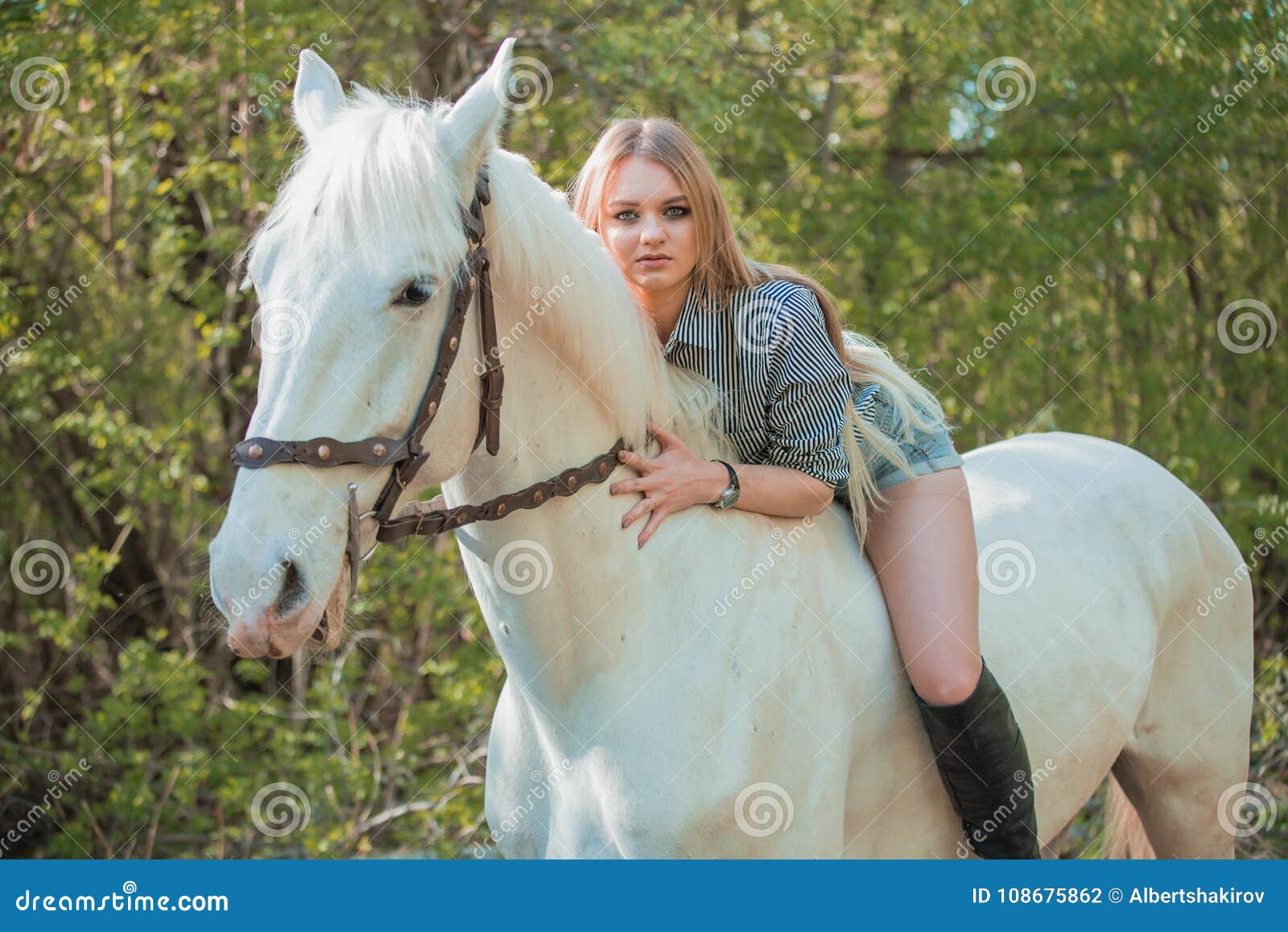 Brunette Woman Riding Dark Horse at Summer Green Forest. Stock Photo ...