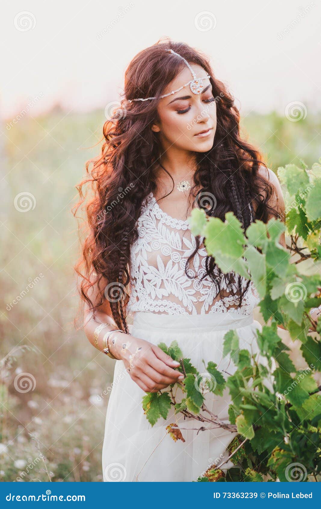 Beautiful Young Woman with Long Curly Hair Dressed in Boho Style Dress  Posing in a Field with Dandelions Stock Image - Image of hippie, female:  73363239