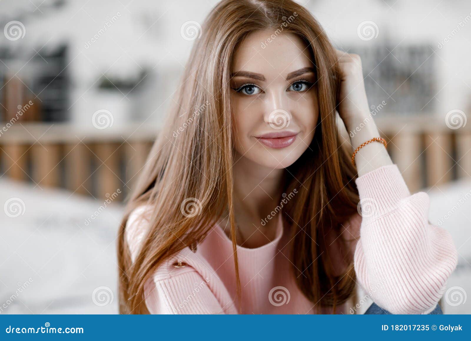 Beautiful Young Woman With Long Hair Posing For The Camera At Home