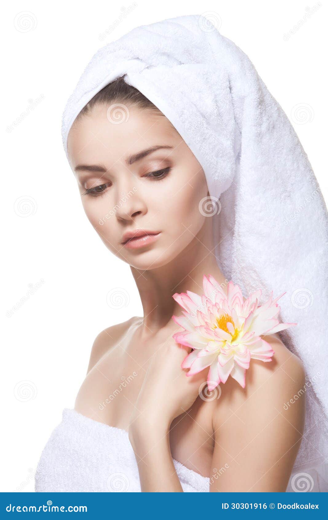 Beautiful young woman posing in white towel. Spa, healthcare. Isolated over white.