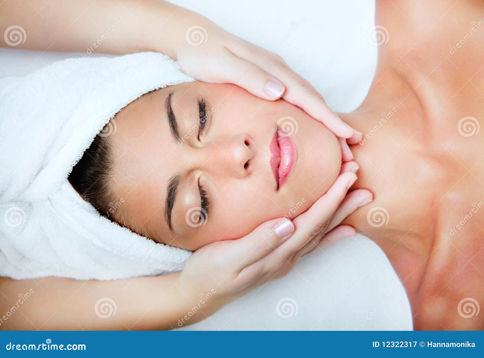beautiful young woman receiving facial massage.