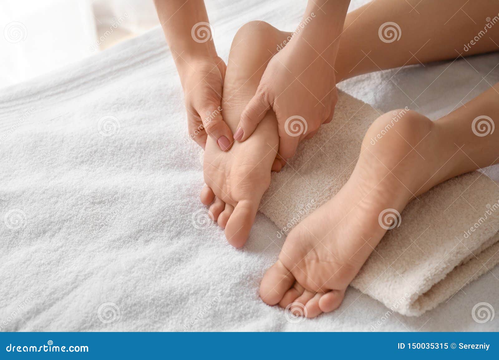 Beautiful Young Woman Receiving Foot Massage In Spa Salon Stock Image