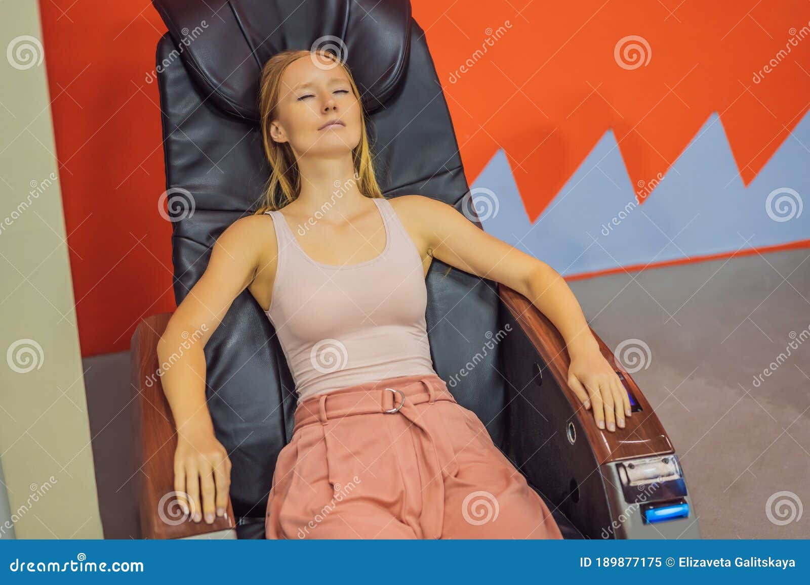 Beautiful Young Woman Relaxing On The Massage Chair In Airport O