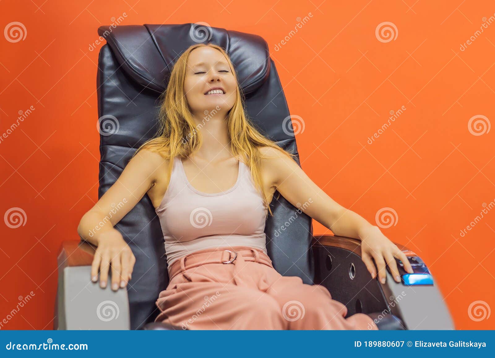 Beautiful Young Woman Relaxing On The Massage Chair In Airport Or In The Mall Stock Image