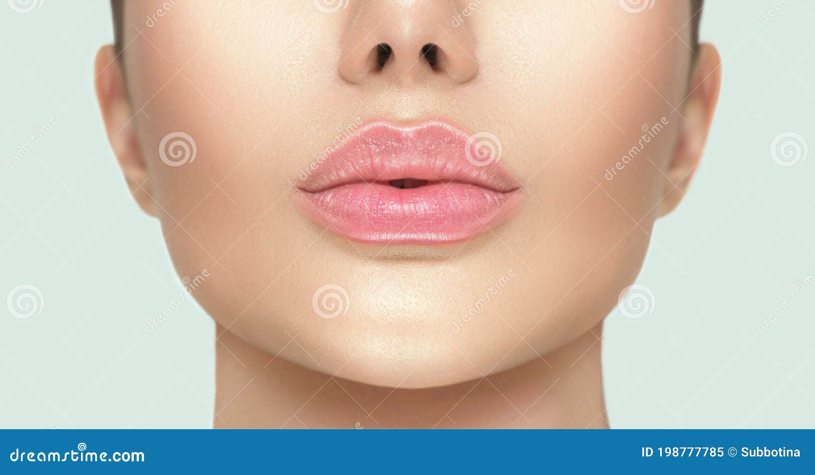 beautiful young woman`s lips closeup. plastic surgery, fillers, injection. part of the model girl face, youth concept