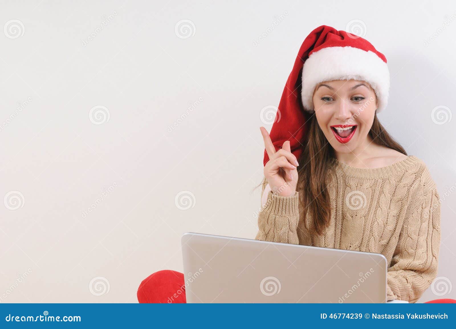 Beautiful young woman in santa hat have an idea of Christmas