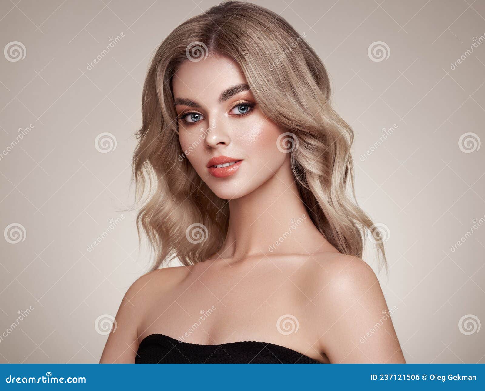 A Beautiful Young Woman With Shiny Wavy Blonde Hair Stock Photo Image