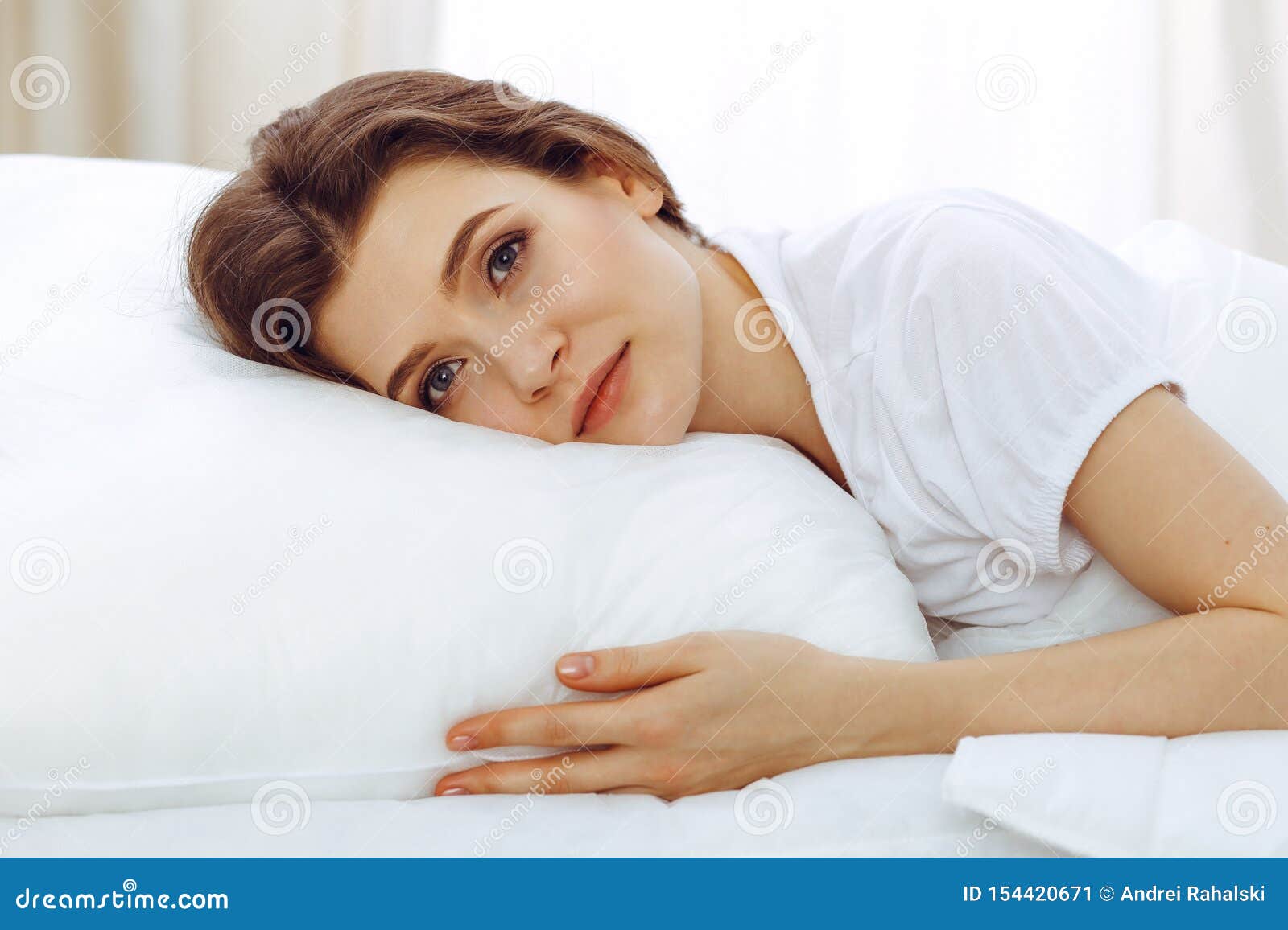 Beautiful Young Woman Sleeping While Lying In Her Bed 